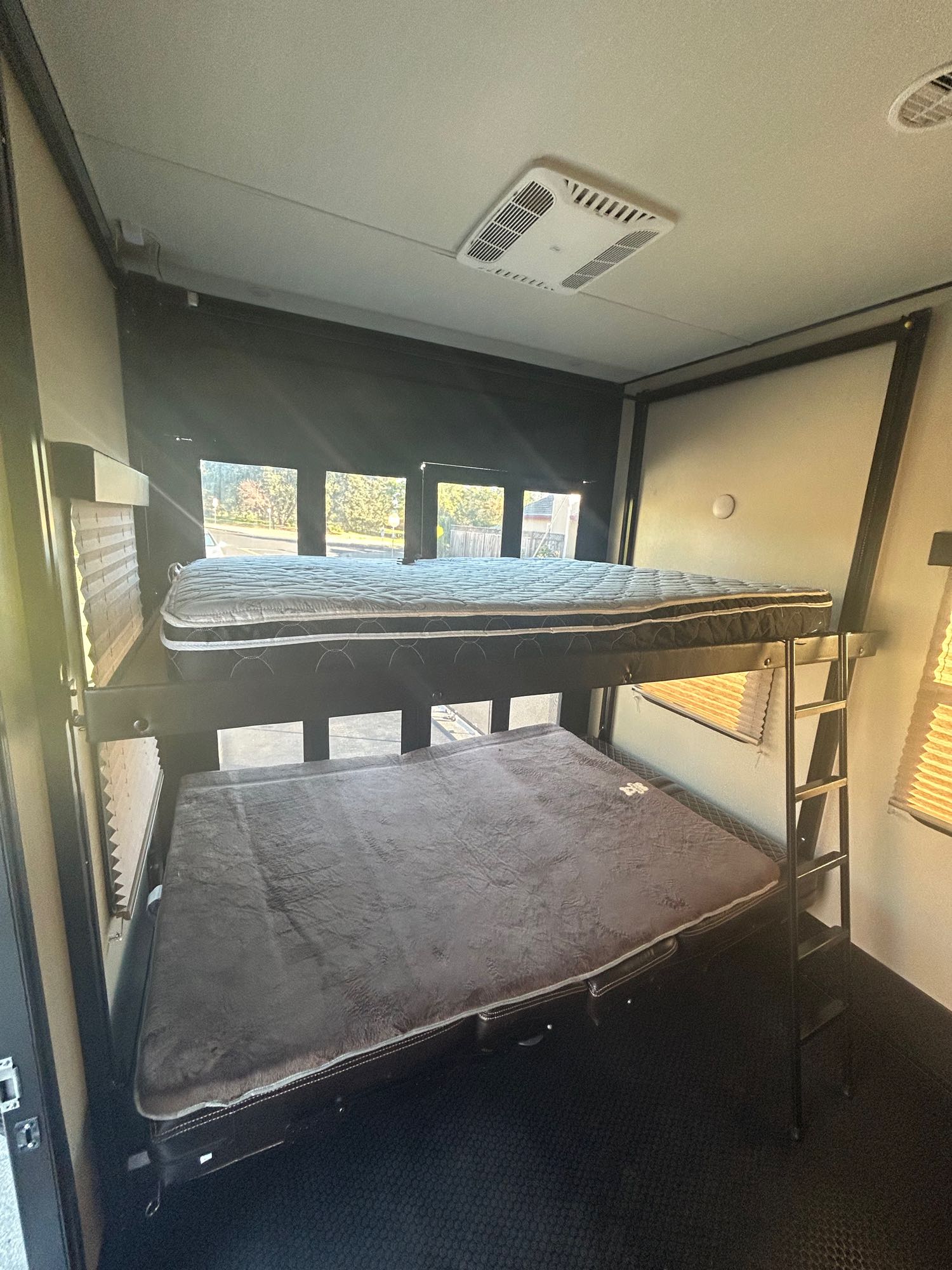 RV rental interior features two bunk beds with mattresses & a ladder, providing comfortable sleeping for guests.. Grand Design Momentum 2017