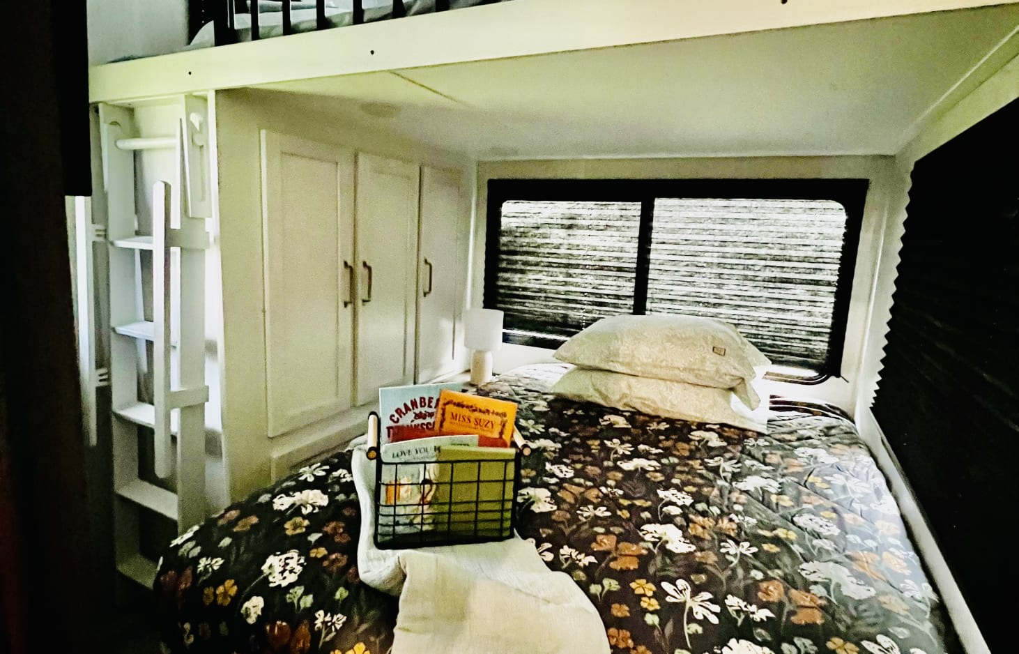 Kids bed on main level of kids suite, side table and closet space; tv on wall across from bed; double bed loft upstairs above this bed; 1/2 bath also in this room (not pictured). Dutchmen 3603LFP 2022