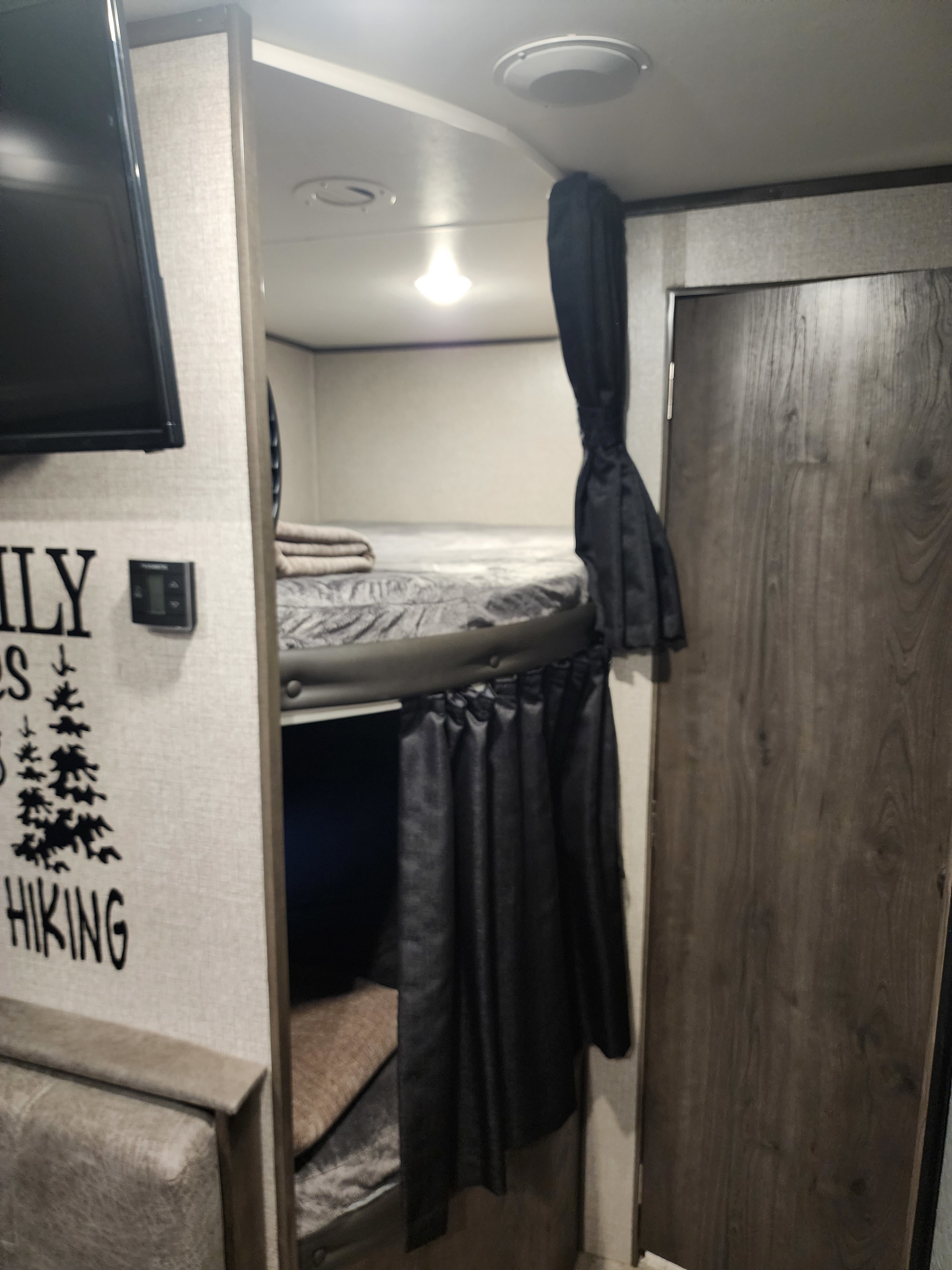 RV rental interior showing cozy bunk beds with privacy curtains, ideal for family travel.. Jayco Jay Flight SLX Rocky Mountain Edition 2020