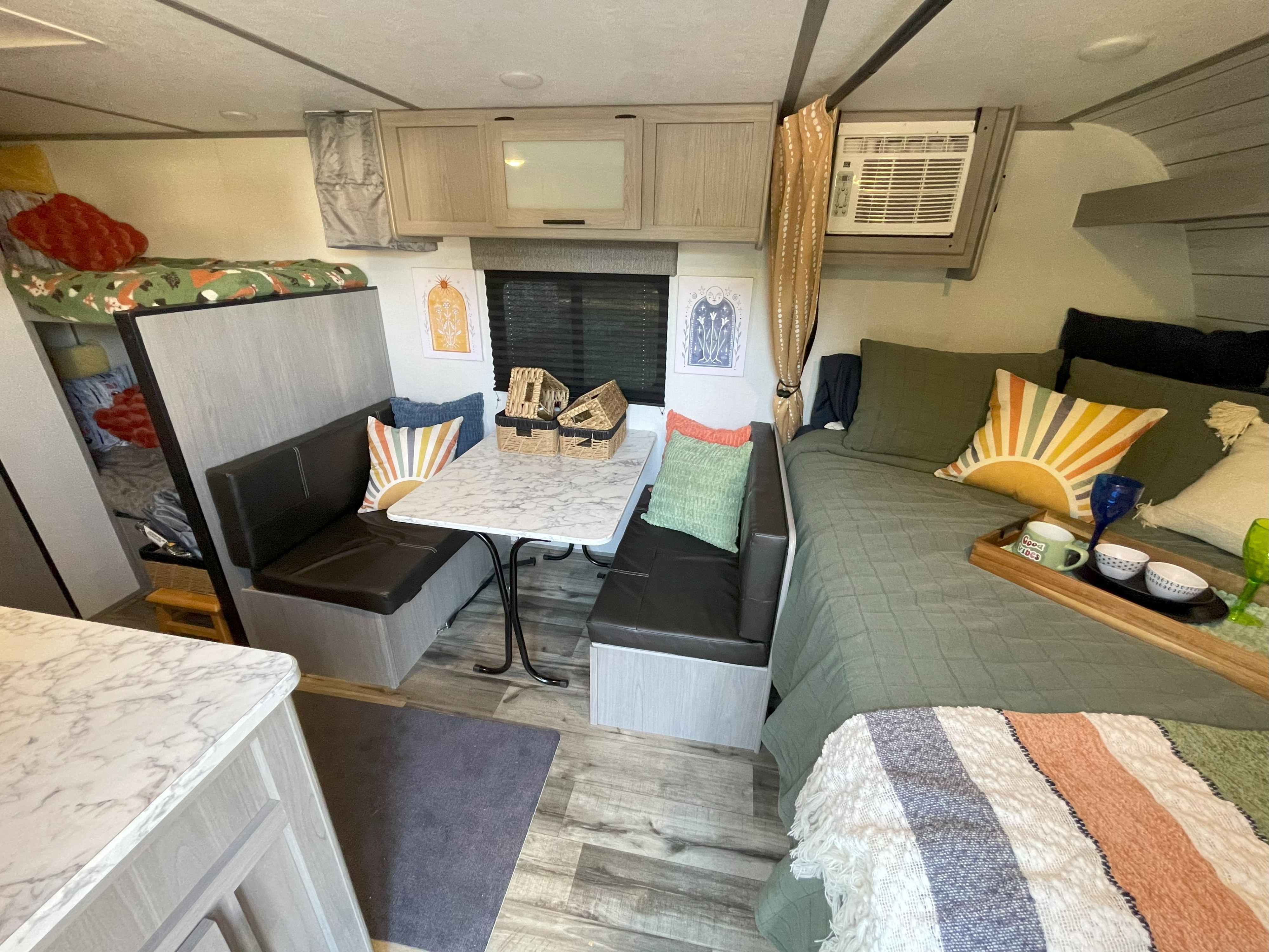 Cozy RV rental interior with dinette, main bed, and bunk for a comfortable travel experience.. Keystone RV COLEMAN LANTERN LT 17B 2024