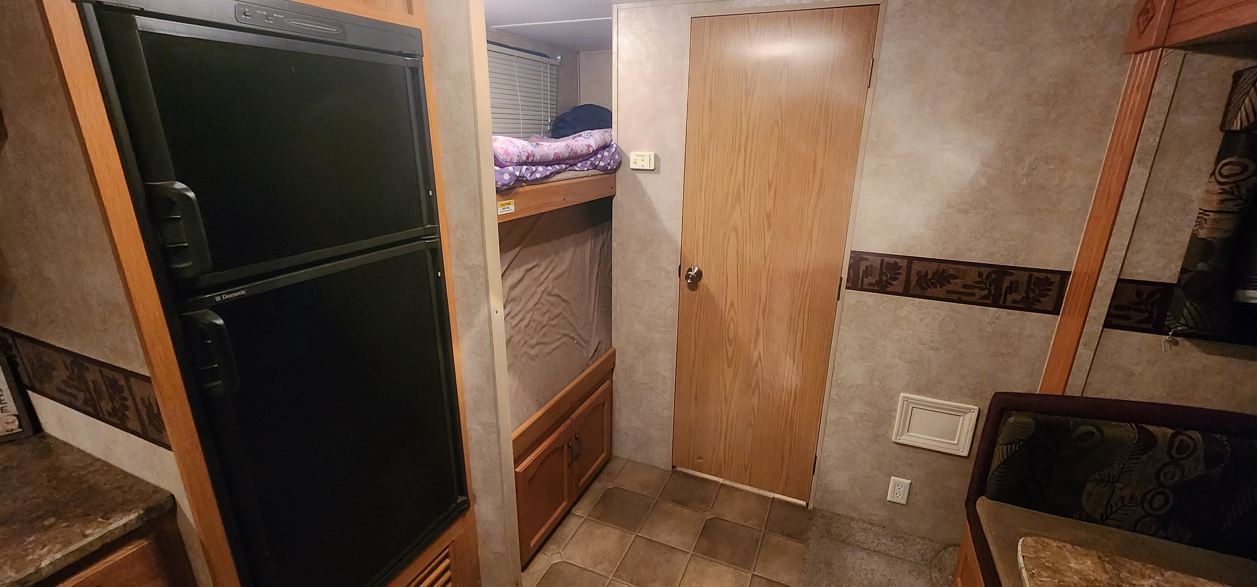 Explore this cozy RV rental with a Dometic fridge, bunk beds, private door, and dining nook.. Keystone Springdale 2010