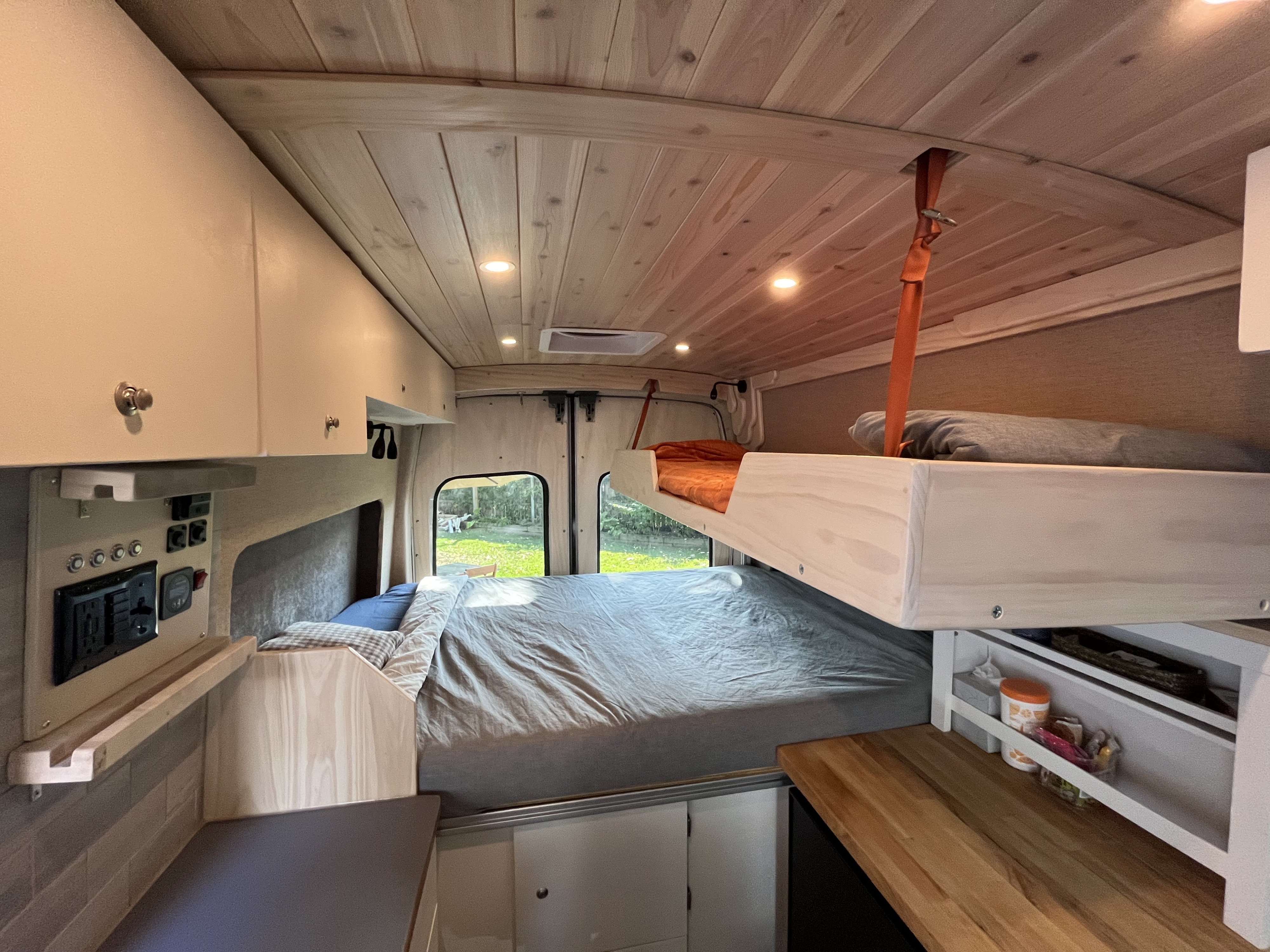 RV rental: View inside a custom camper van with bunk bed, main bed, and practical control panel. Ready for adventures!. Custom Built Transit 2017