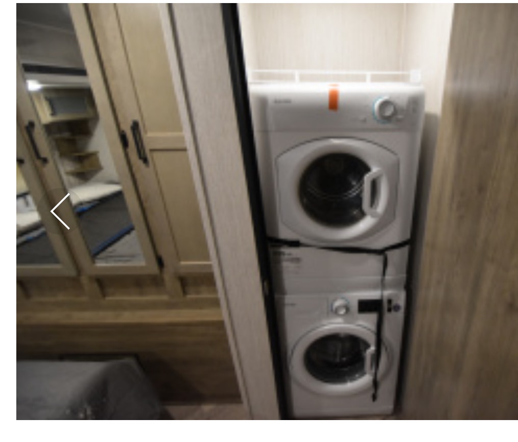RV rental offers a stacked white washer and dryer unit, providing convenient laundry solutions onboard.. Palomino Puma Park Trailer 2021