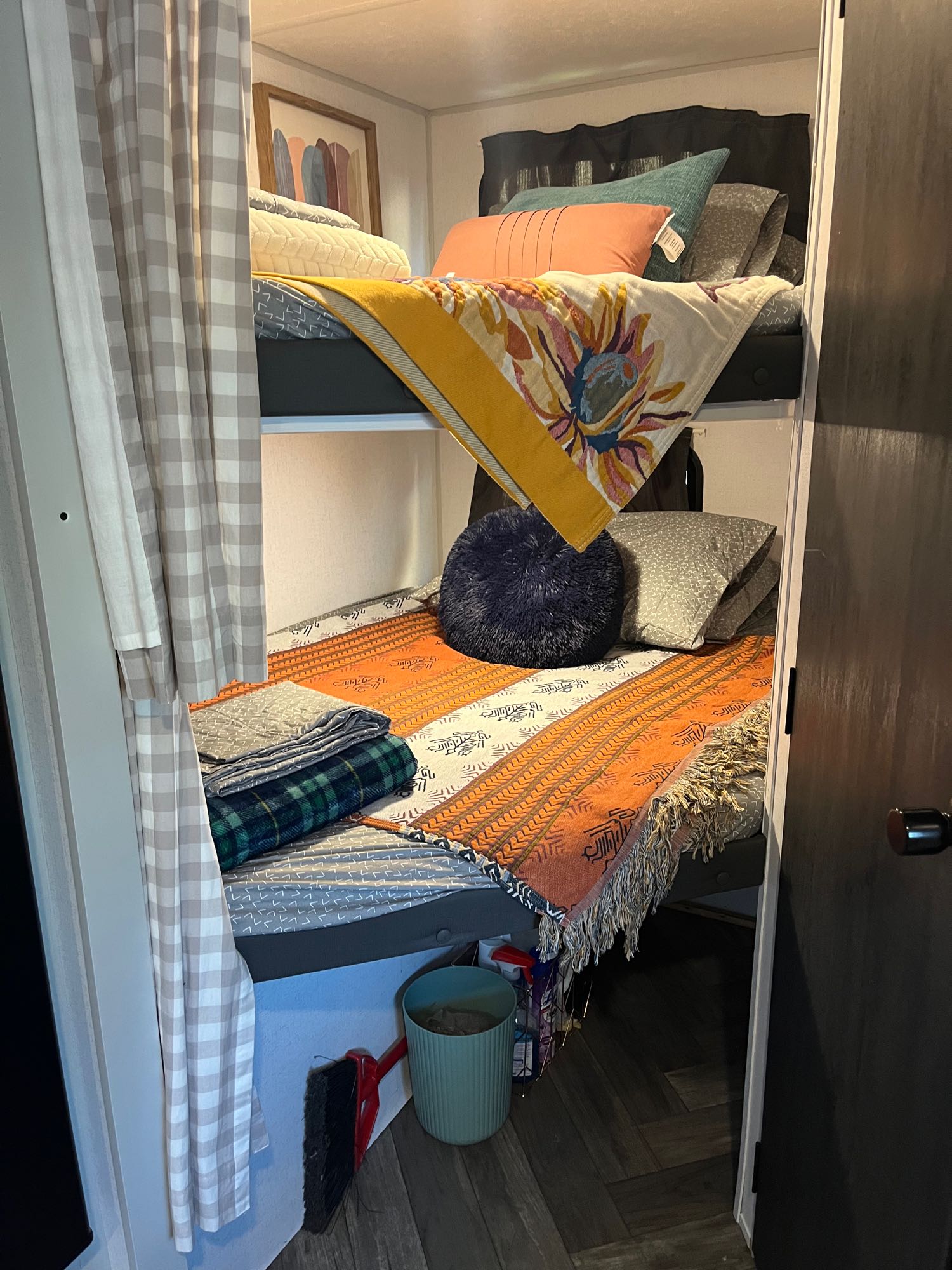 This RV rental features stacked bunk beds with colorful, inviting bedding and a privacy curtain, ideal for guests.. Forest River Wildwood FSX 2021