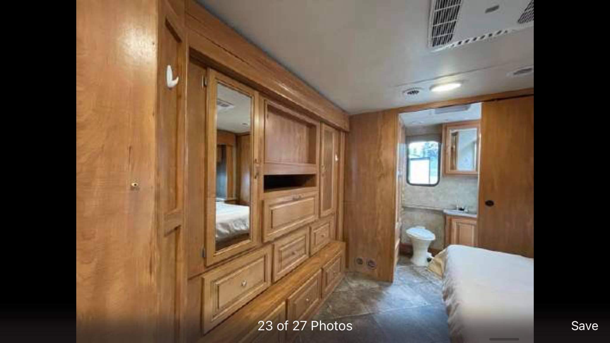RV rental: Bedroom with built-in wooden storage, mirrored closet doors, and access to a compact bathroom.. Nexus RV Maybach 2018