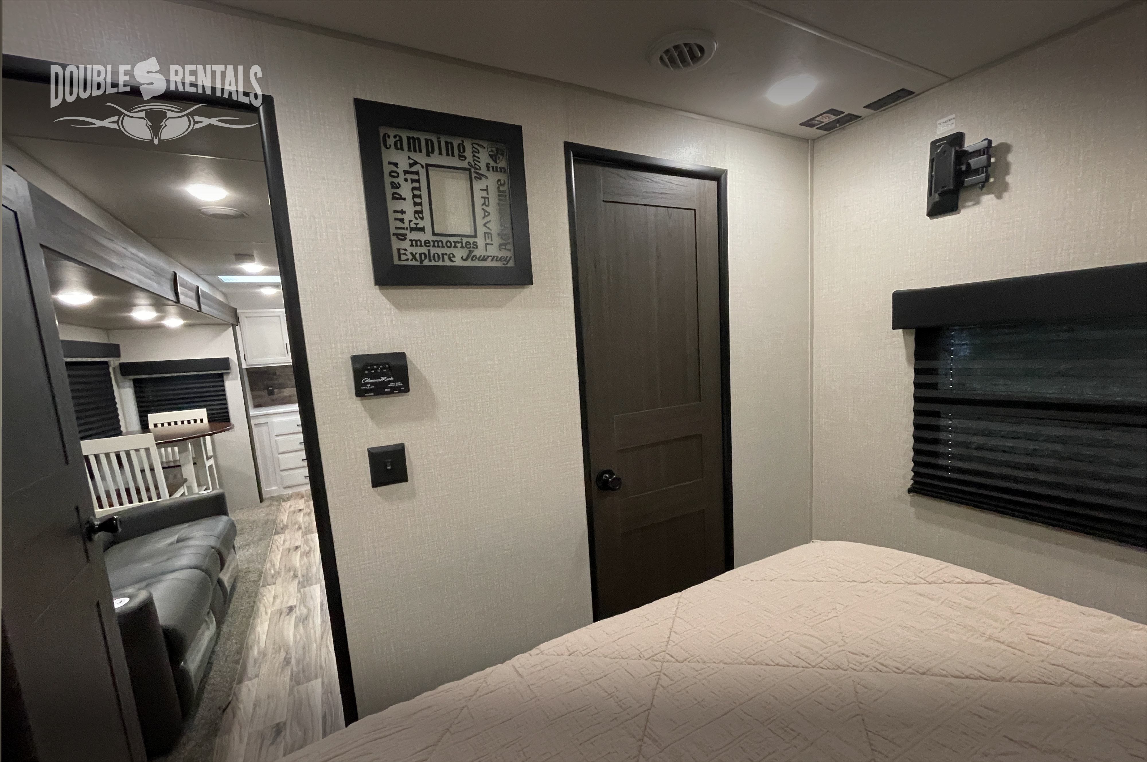 Cozy RV rental interior, featuring a bedroom, compact living area & kitchen. Perfect for adventure & family memories.. Venture Rv Sporttrek 2021