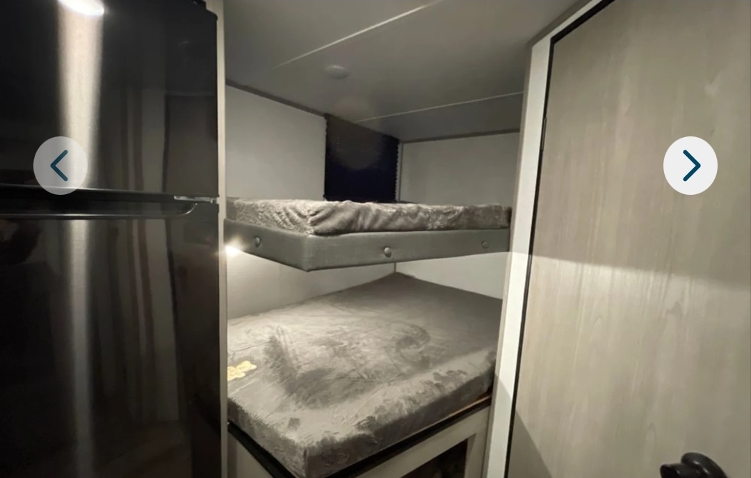 RV rental: Bunk beds with mattresses and a dark refrigerator maximize sleeping space in this compact RV.. Dutchmen Coleman Lantern Lt 19BB 2024
