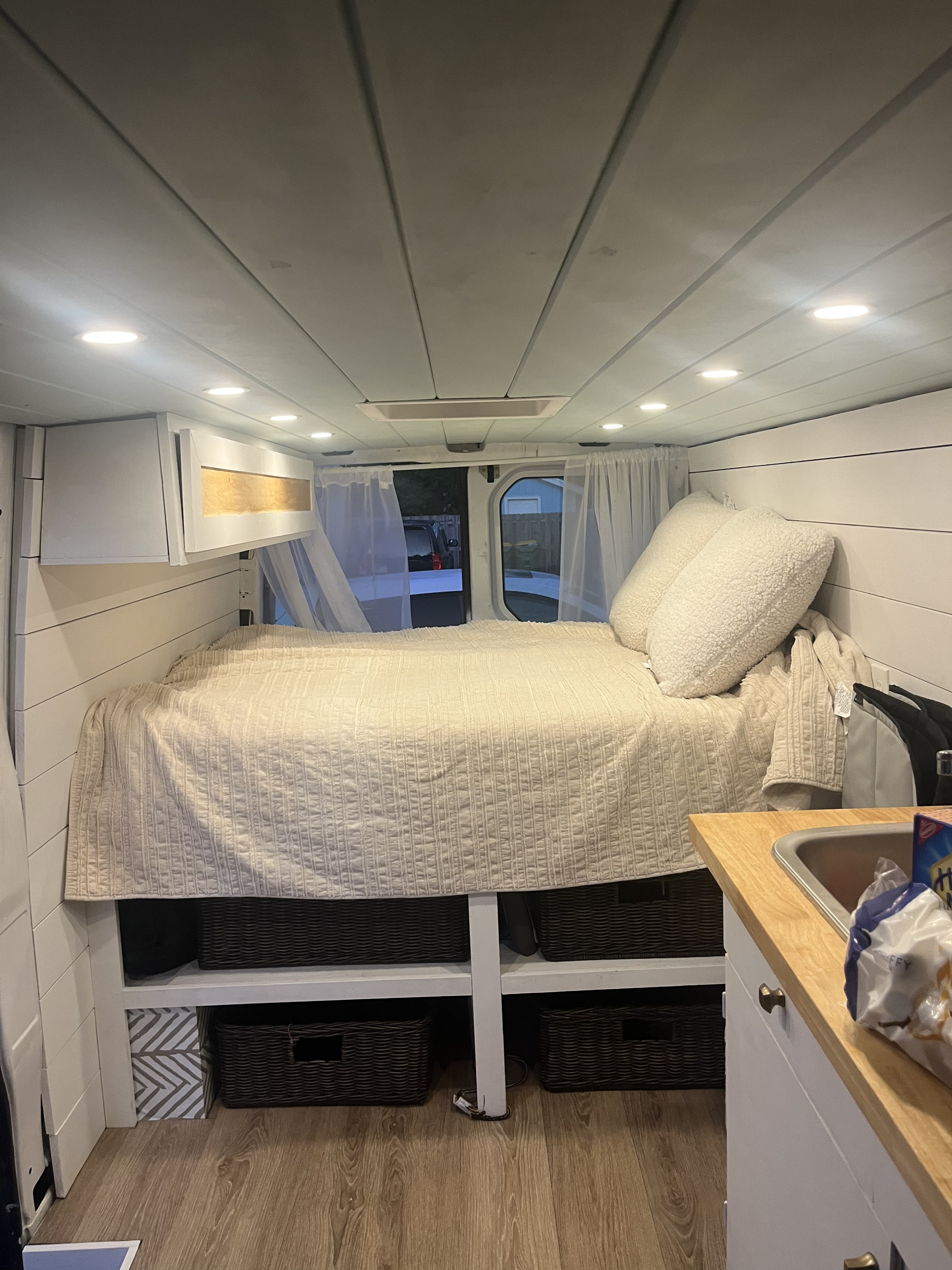 Experience van life in this cozy rv rental! Features a comfortable bed, kitchen area, and organized storage inside.. Dodge Sprinter Van 2008