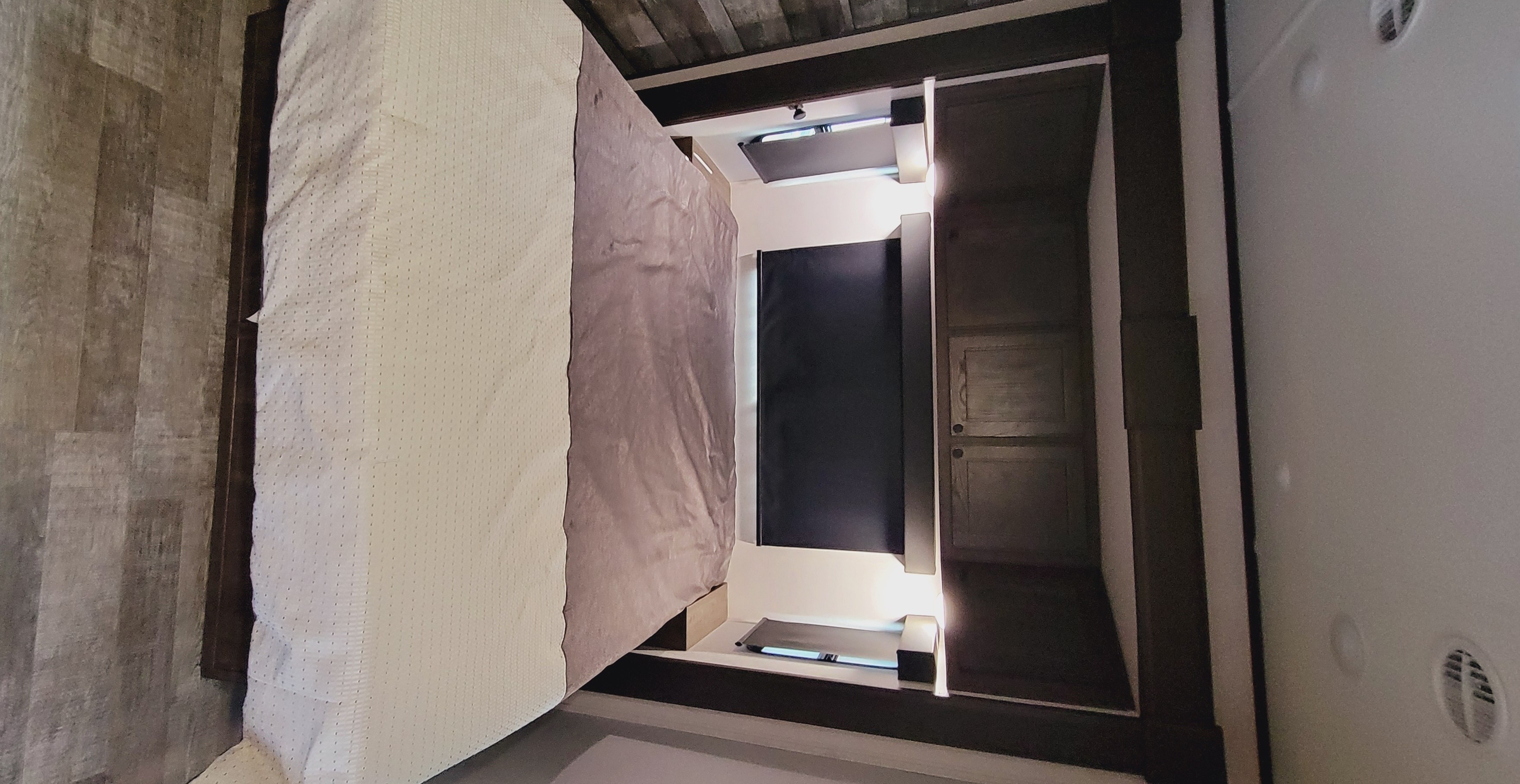 Overhead view of a spacious RV rental bedroom with a large bed, textured flooring, and sleek built-in storage.. Forest River XLR Hyperlite HD 2020