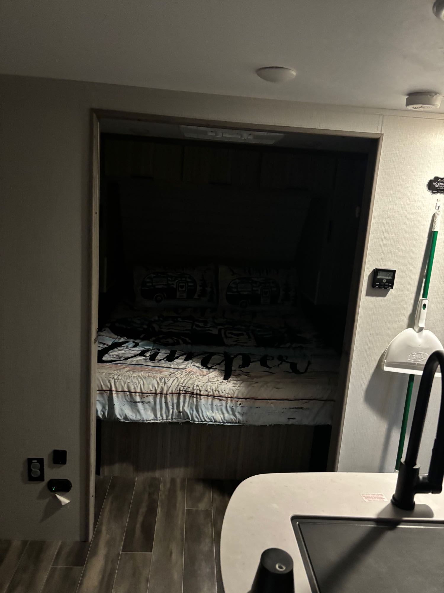 Cozy rv rental interior: main living area with a partial kitchen sink and view into the compact bedroom. Ideal for road trips.. Keystone RV Passport SL 2021