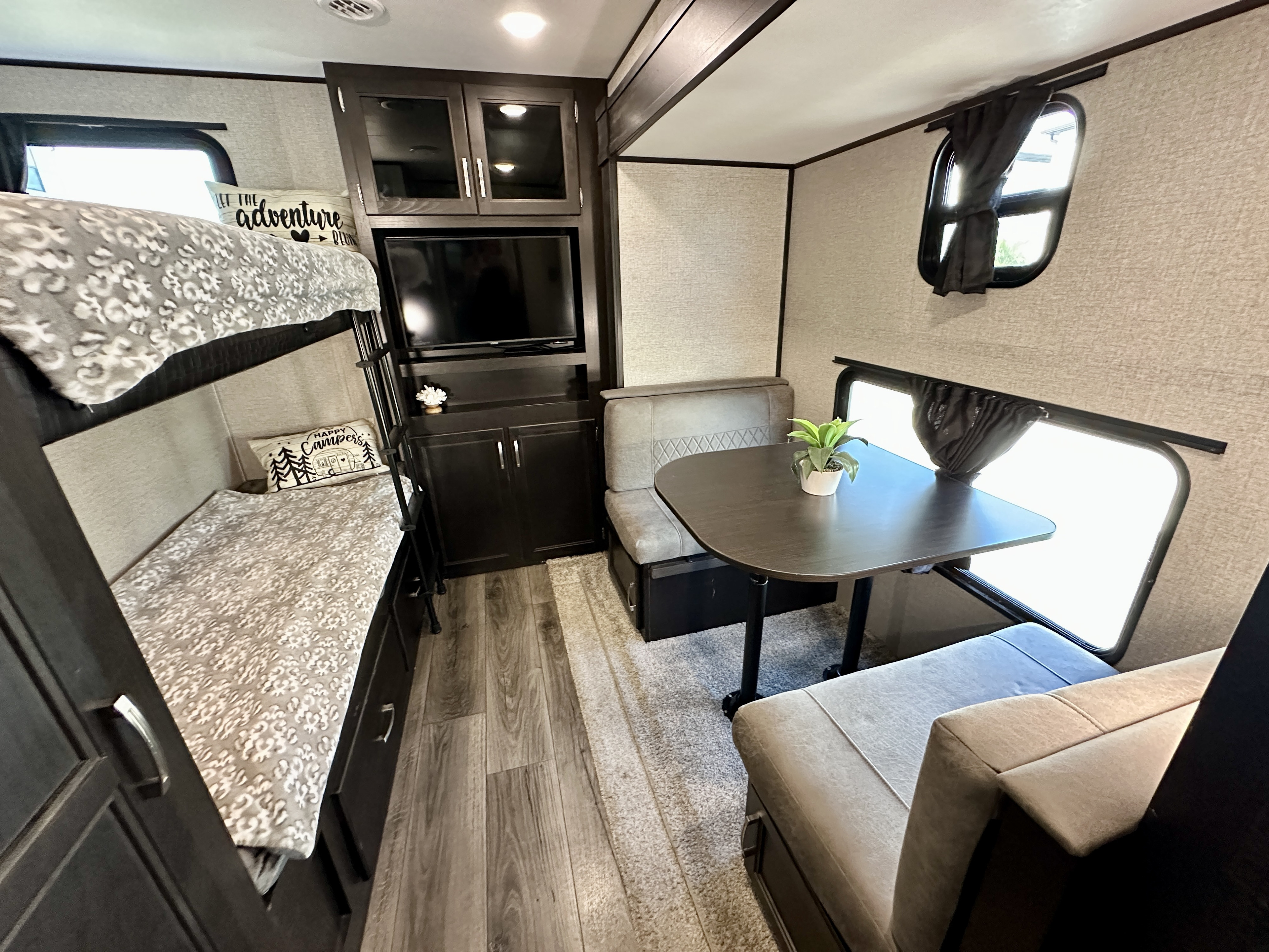 Step inside this RV rental showcasing modern bunk beds, a cozy dinette, and TV area for family adventures.. Jayco Jayflight 2021