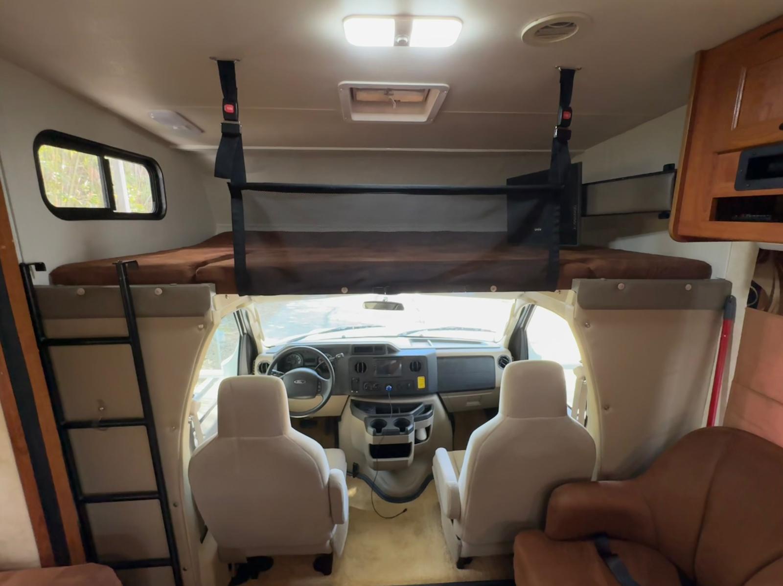 Spacious overhead bunk with safety net and ladder, above the front cab provides a large sleeping area.. Forest River Coachmen Freelander 2011
