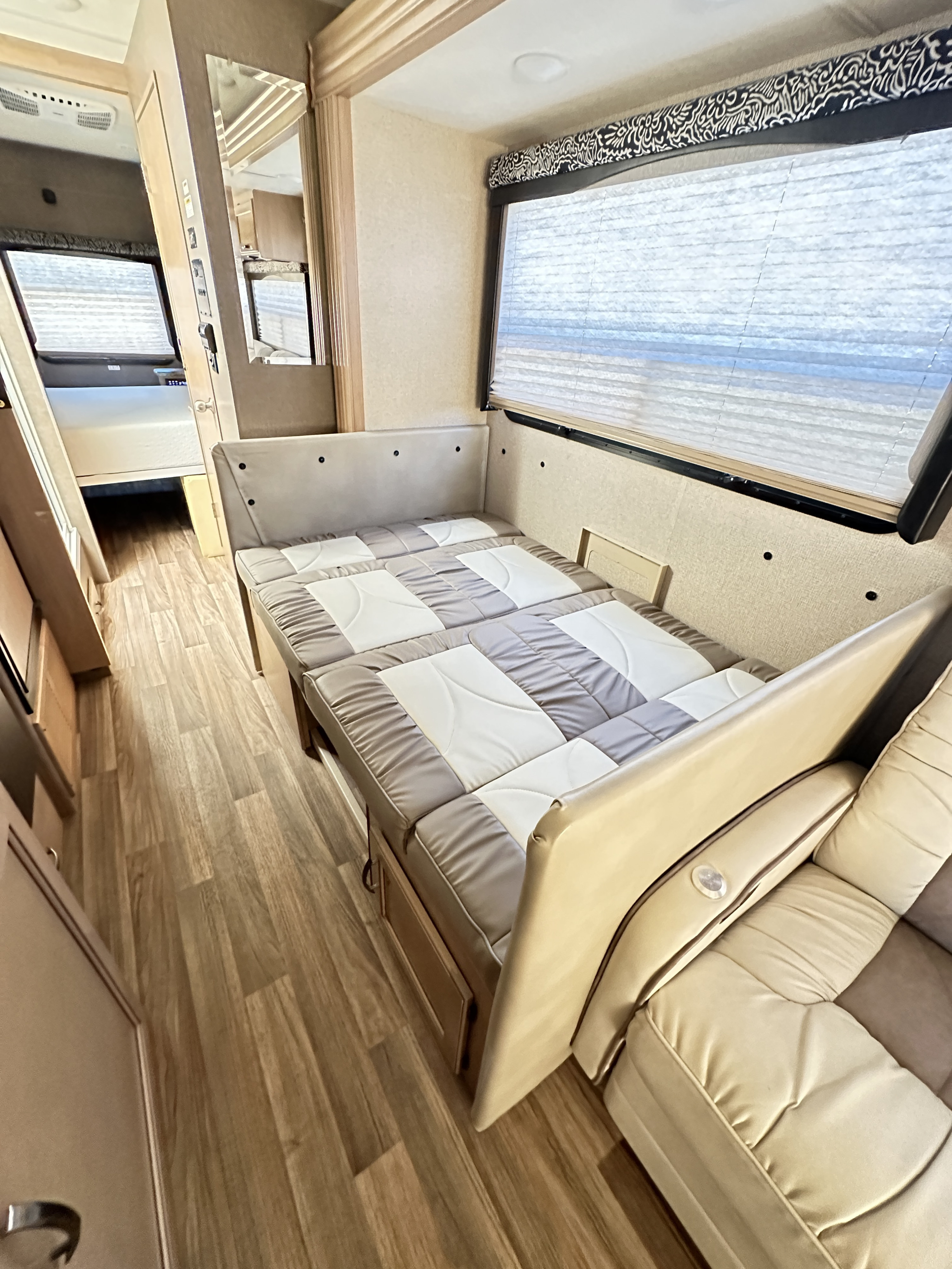 Spacious RV rental interior featuring a convertible dinette bed and comfortable lounge seating for travelers.. Thor A.C.E. 2018