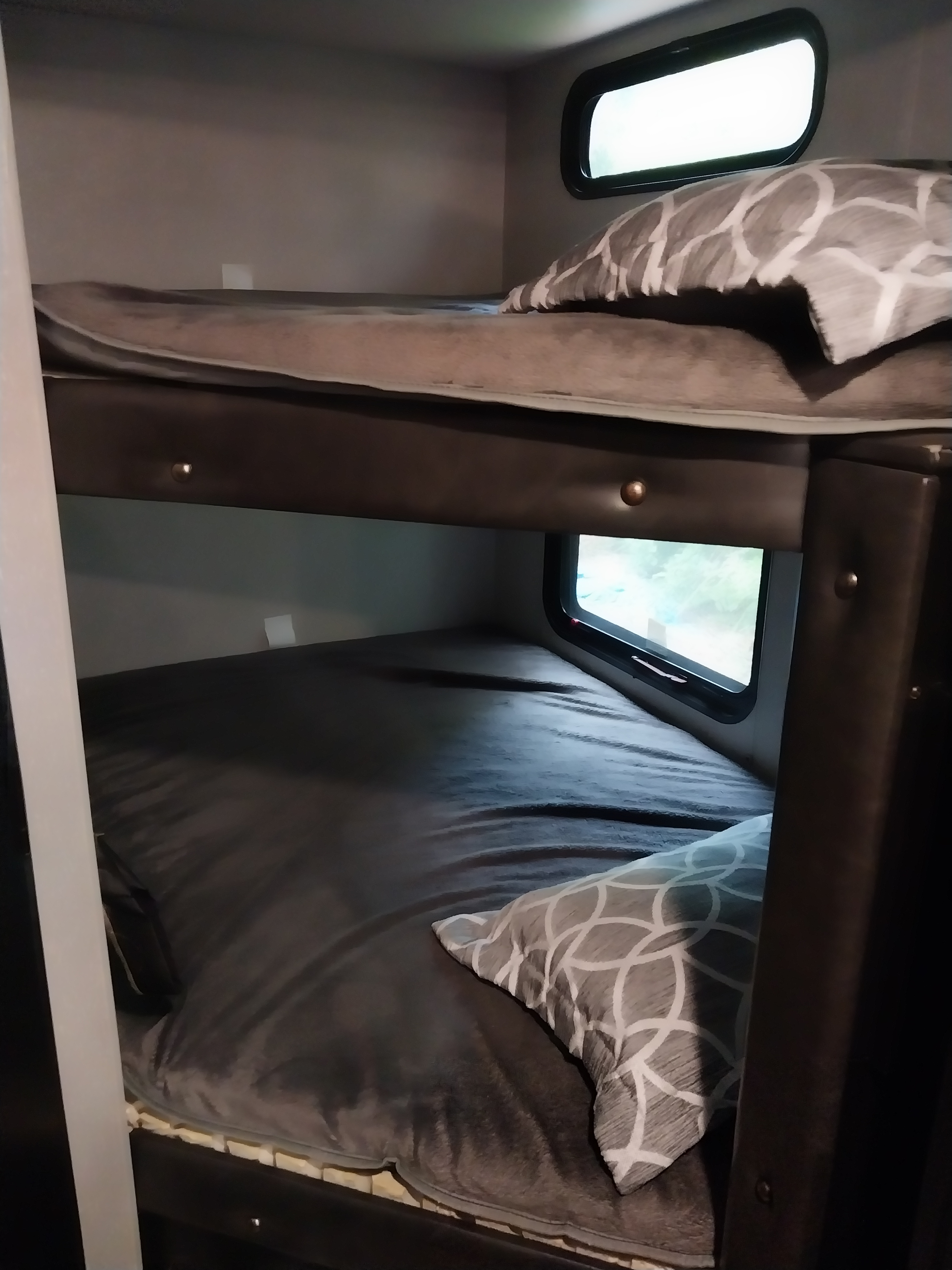 Cozy RV rental bunk beds with windows, perfect for family travel accommodations. Enjoy comfort on the go!. Forest River Cherokee Grey Wolf Black Label 2021