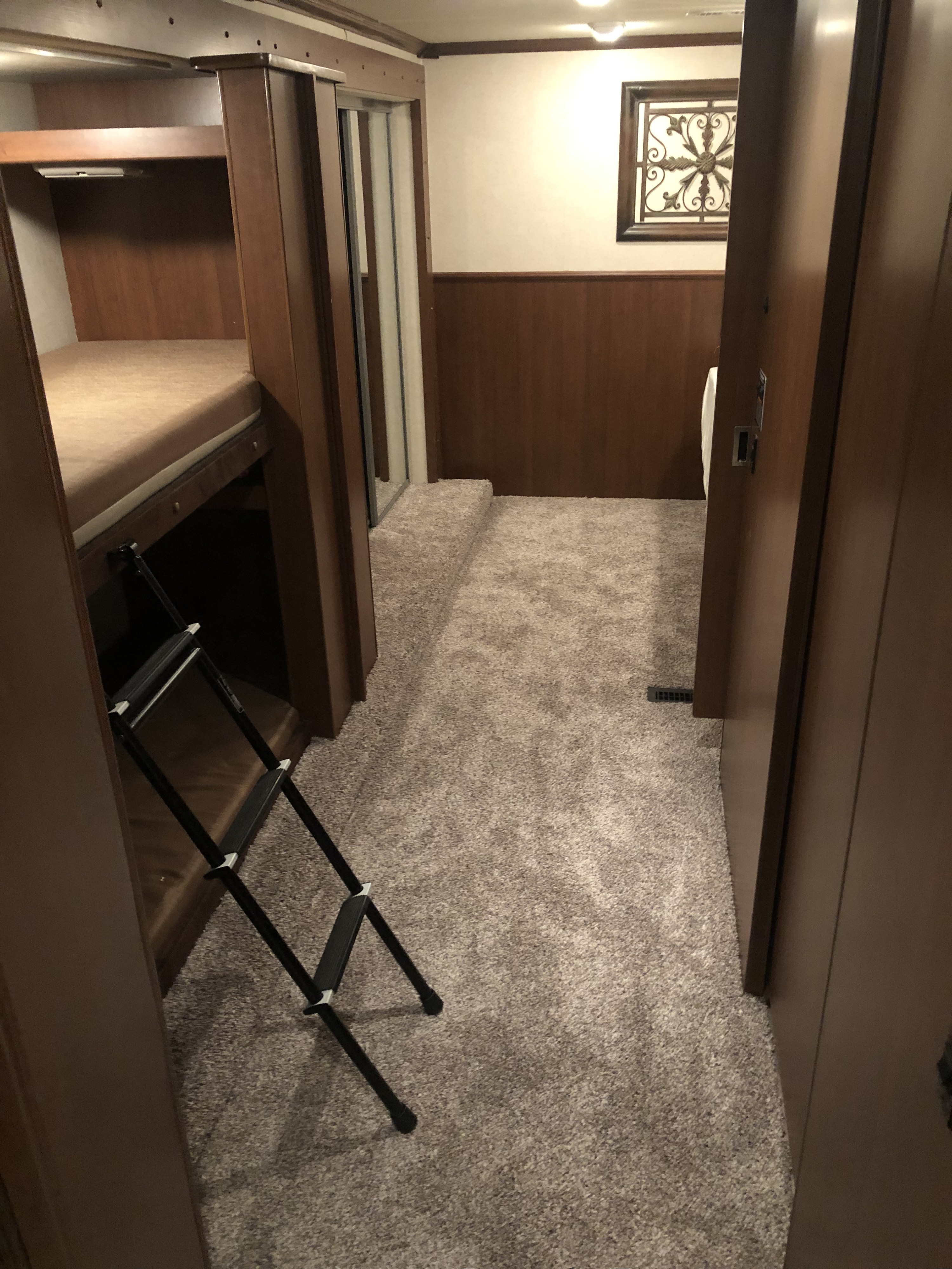 RV rental interior featuring comfortable bunk beds, plush carpeted floor, and a warm, inviting living area.. Fleetwood Bounder 34B 2011