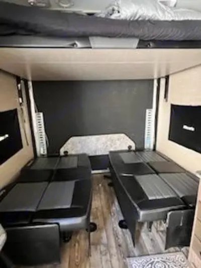 RV rental: Spacious toy hauler interior with a high bunk bed and two convertible sofa beds on the floor.. Pacific Coachworks Blaze'N 2017