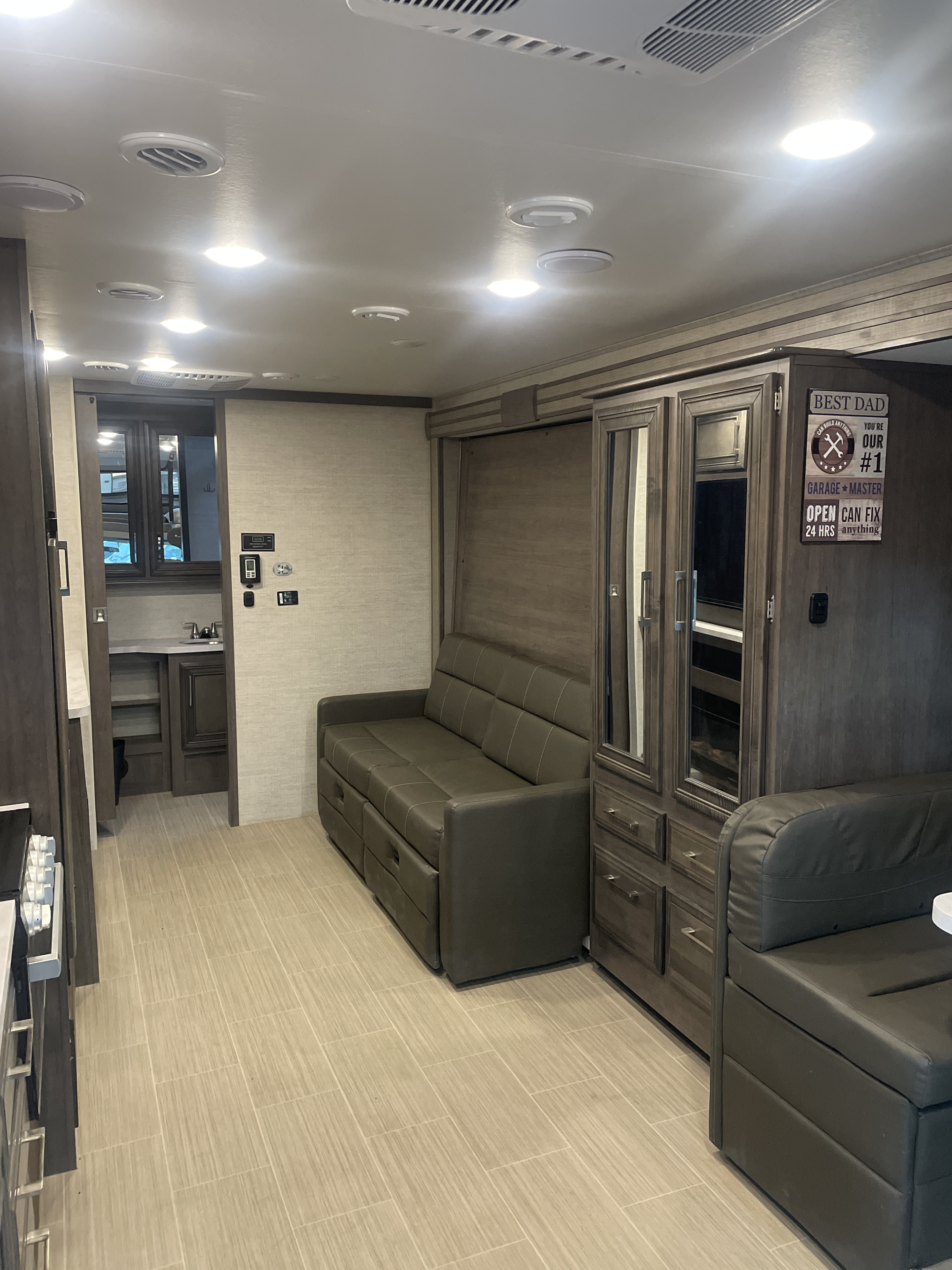 RV rental interior with a pull-out sofa bed, ample storage, and a connecting bathroom. Bright and functional living space.. Entegra Coach Other 2022