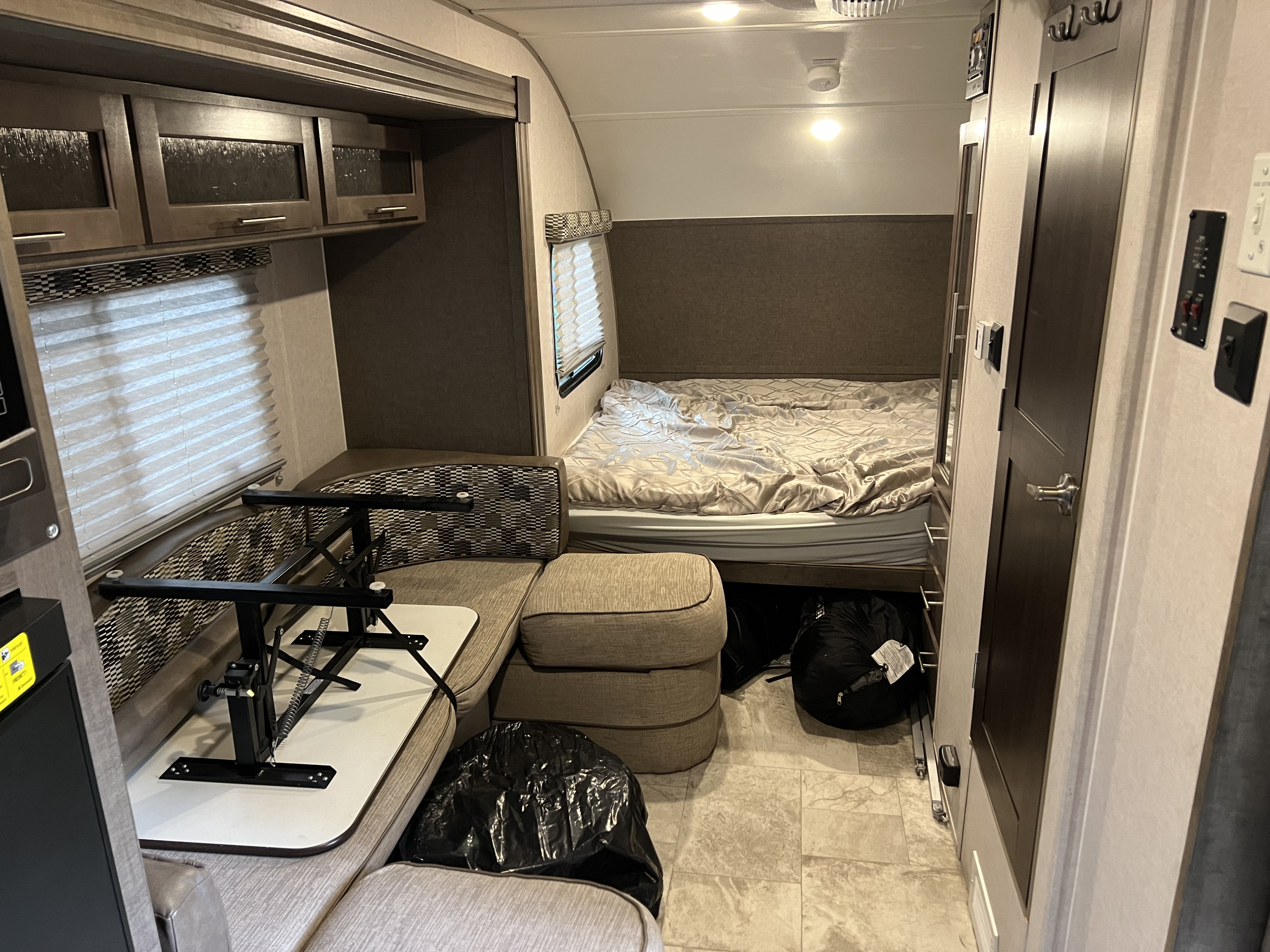 Inside this rv rental, find a comfortable bed, versatile dinette seating with a stowed table, and overhead cabinets for storage.. Forest River R-Pod 2018