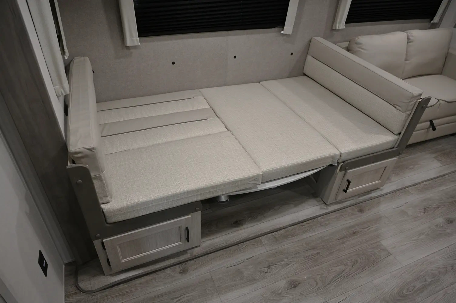 RV rental: Light fabric RV dinette seating flattened into a bed, offering comfy sleeping in this travel trailer.. Catalina Legacy 263BHSCK 2025