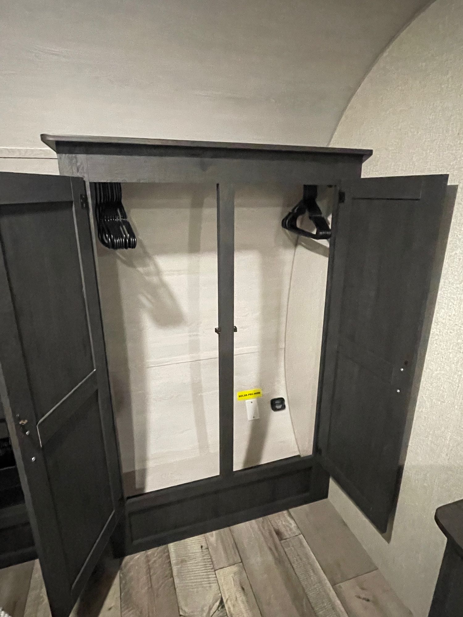 RV rental: Dark wood wardrobe, open, with hangers. Essential storage for your travel needs.. KZ Sportsmen 2022