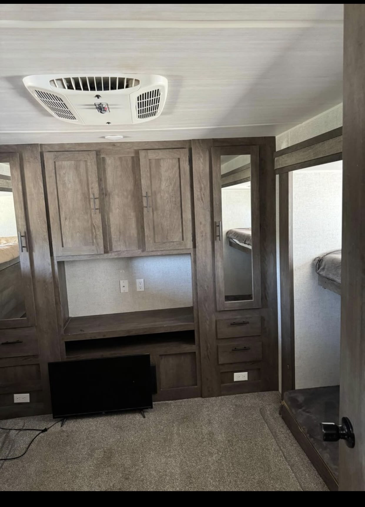 Spacious RV rental interior with bunk beds, entertainment unit, and AC, ready for travel.. Forest River Wildwood 2020