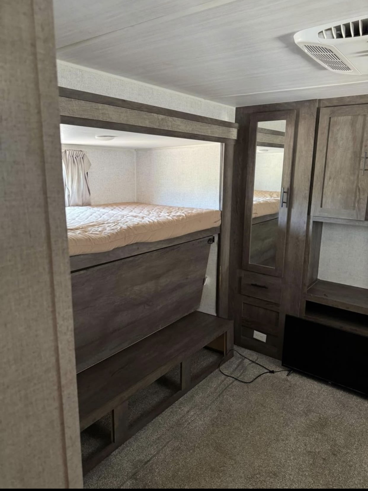 Inside this RV rental: comfy bunk beds, built-in storage, mirrored closet, and entertainment. Functional design.. Forest River Wildwood 2020