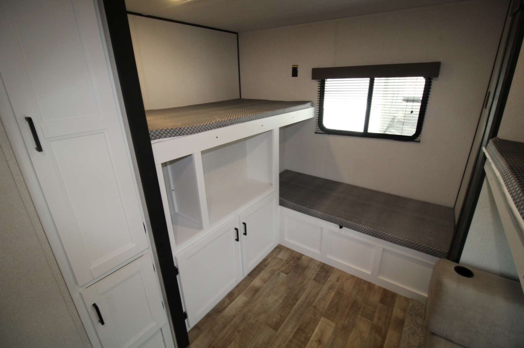 RV rental bunk room: upper bunk, lower bench with storage & shelves, window, and cabinet. Great for family trips.. Keystone RV Hideout 2022