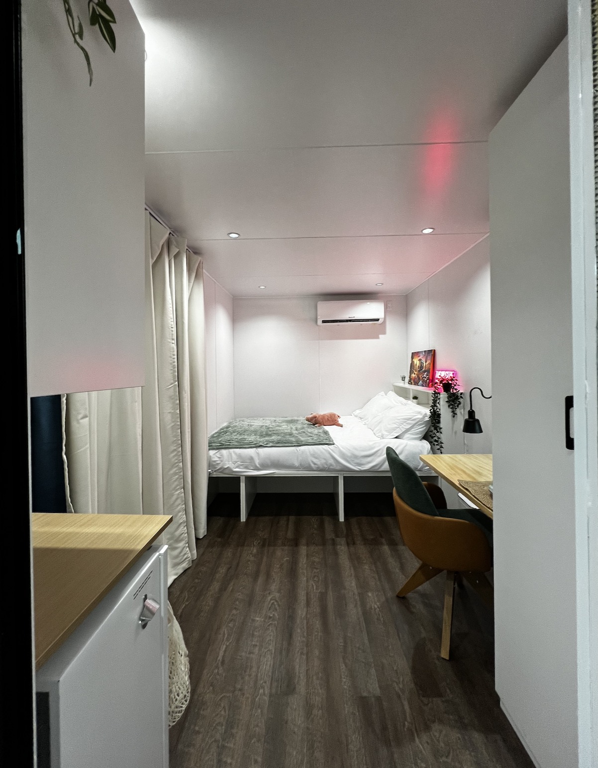 Cozy RV rental: a modern, compact living space with a bedroom area, desk, and white interior.. Custom Custom 2024