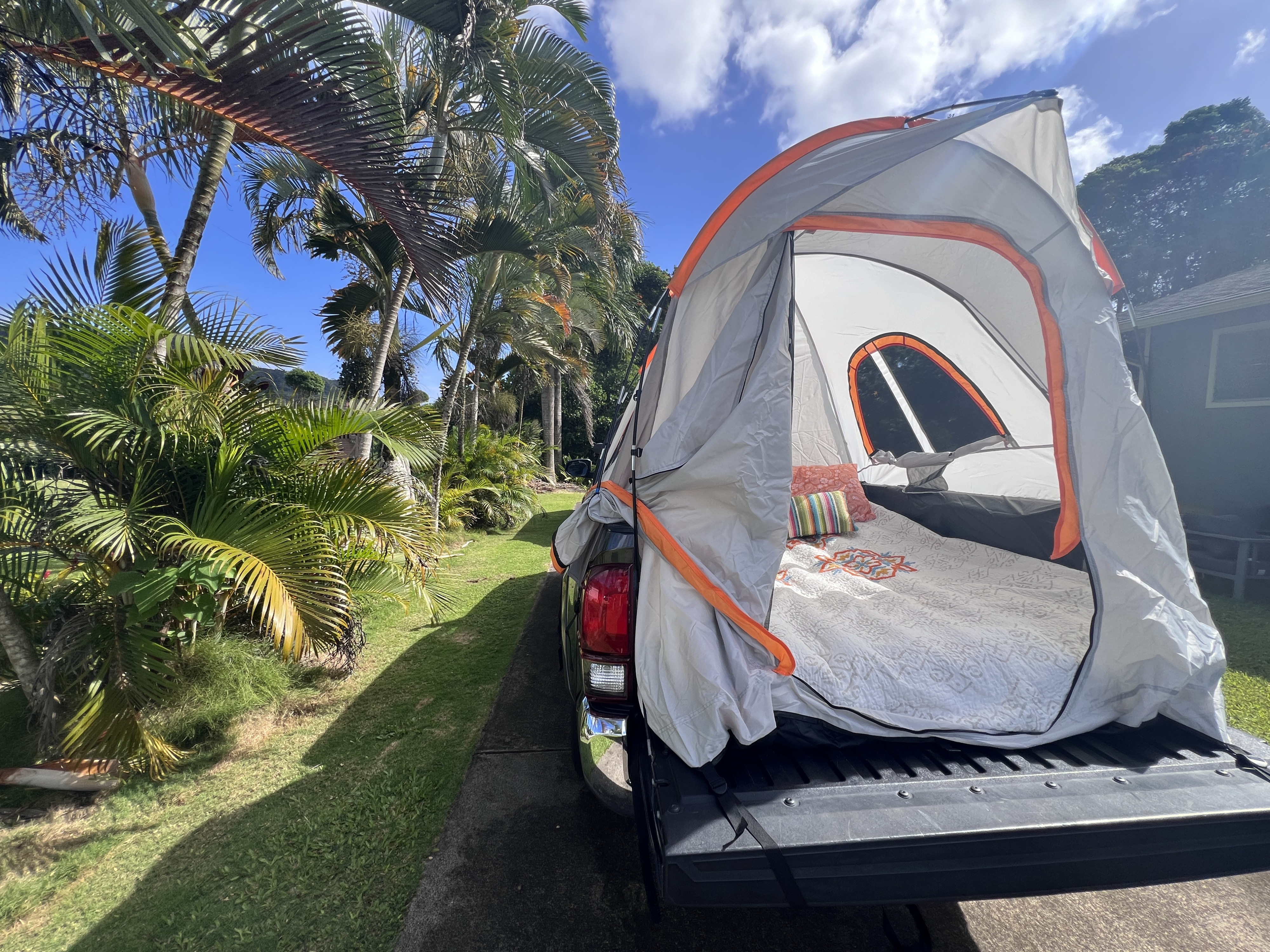 This truck bed tent transforms a pickup into a cozy, portable RV rental for camping. Lush palm trees line the sunny drive.. Xplorer Toyota Tacoma SR5 2018