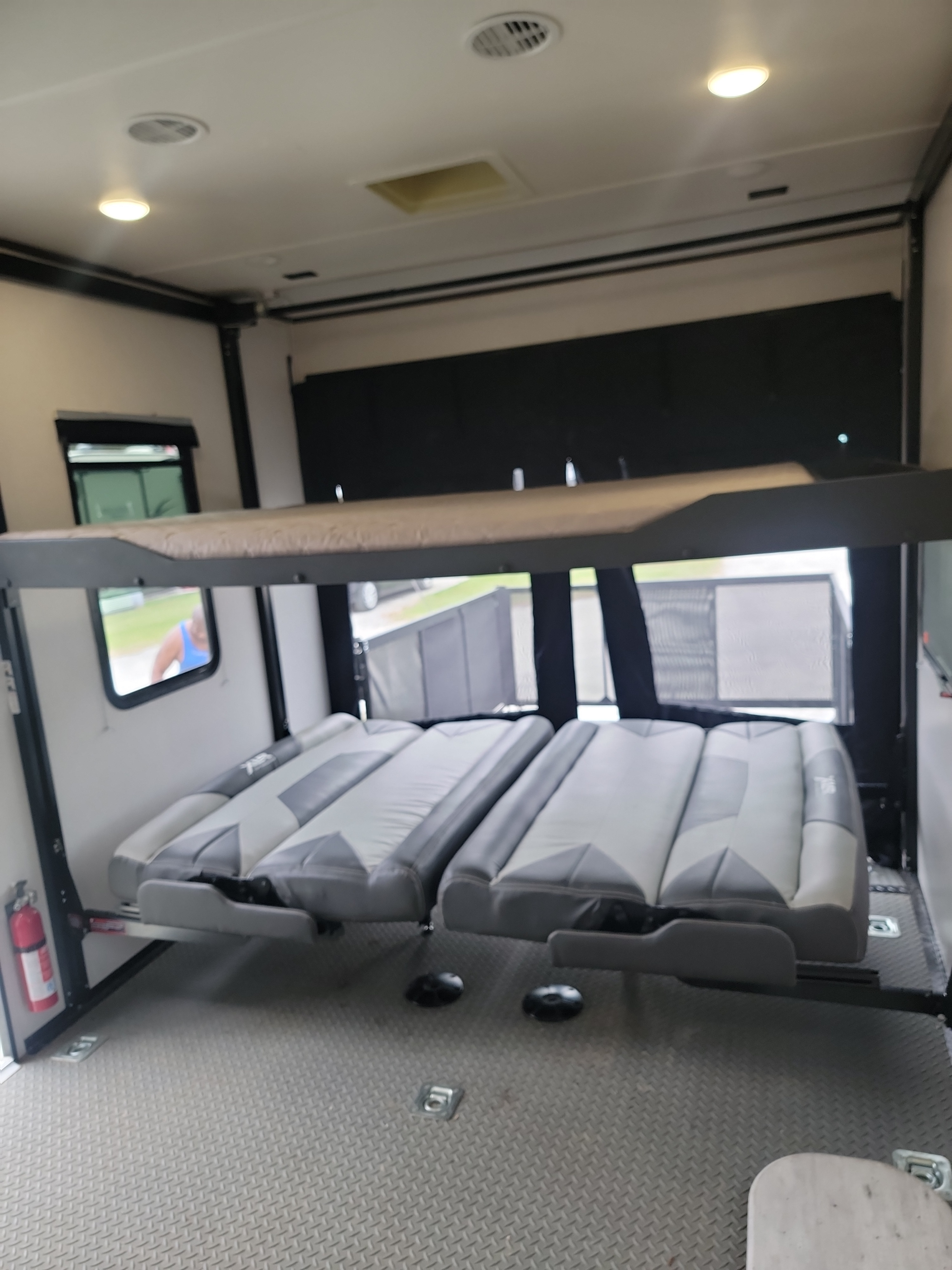 RV rental interior featuring an elevated bunk bed, convertible seating/beds, and a durable floor. Ready for your trip!. Forest River Hyperlite HD 2021