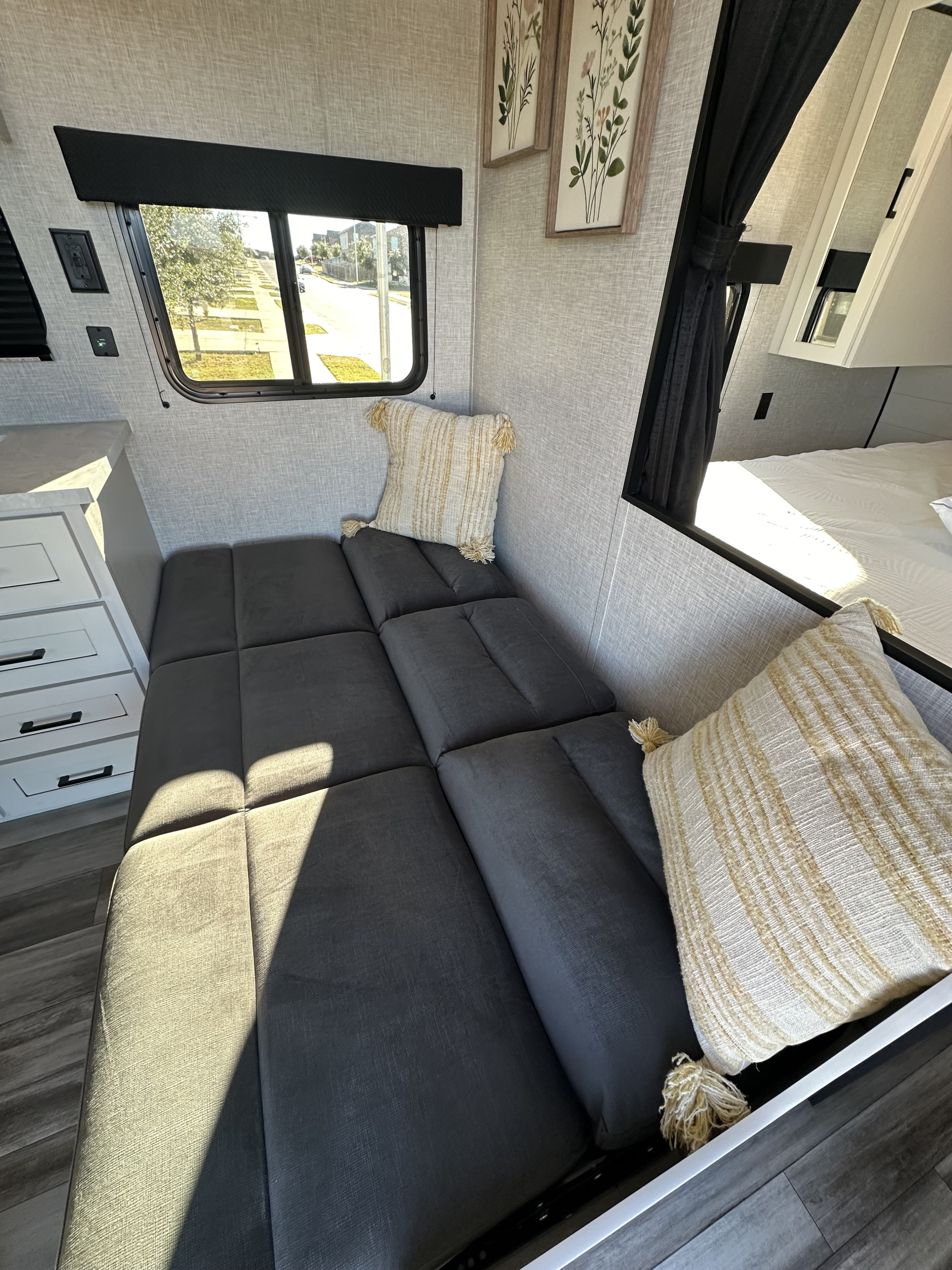 Cozy RV rental interior with convertible seating, a bright window view, and modern amenities for your next adventure.. JAYCO JAY FLIGHT 260BH 2025