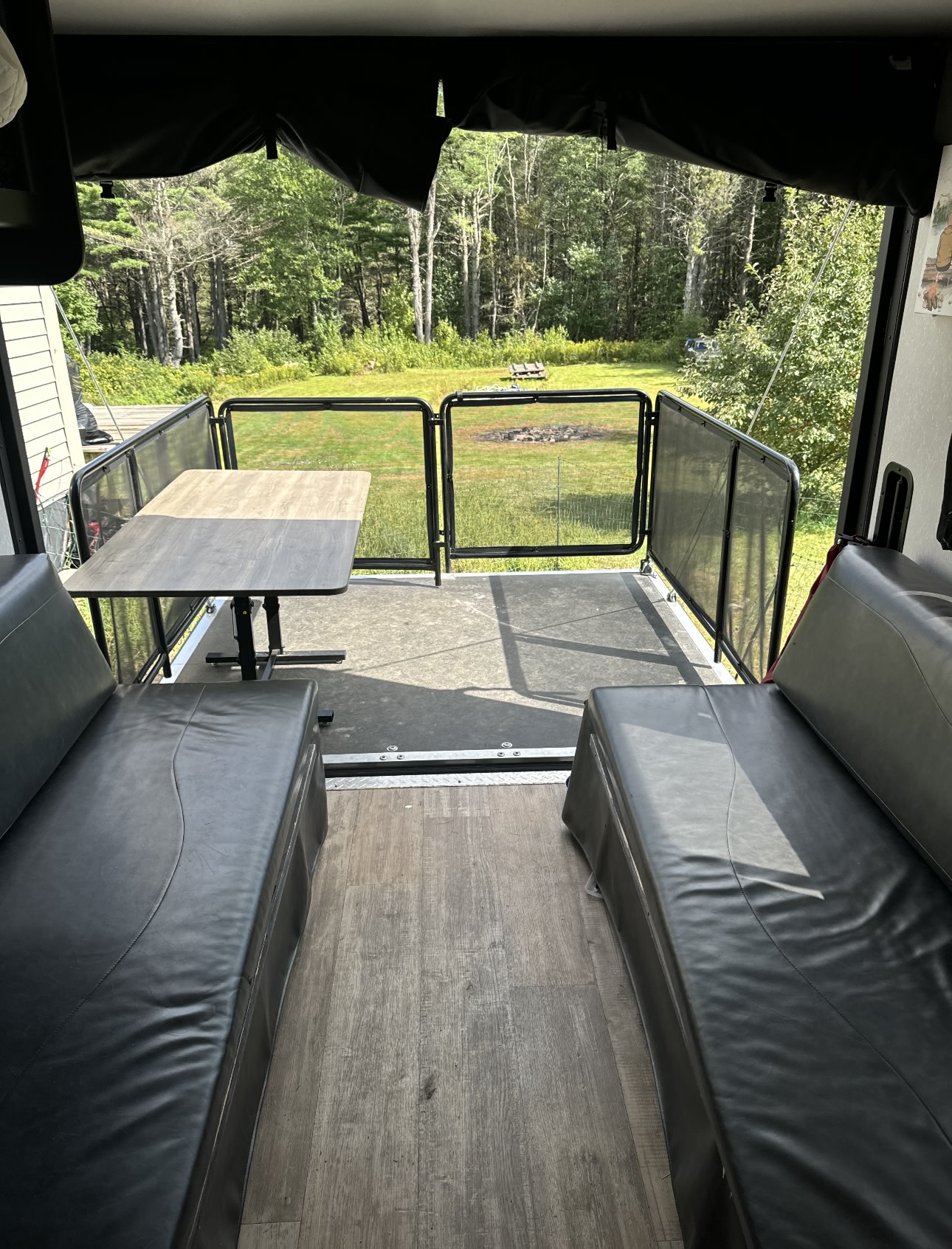 Enjoy nature from your RV rental patio! This comfy space has benches, a table, and scenic forest views.. Forest River Cherokee Grey Wolf 2021