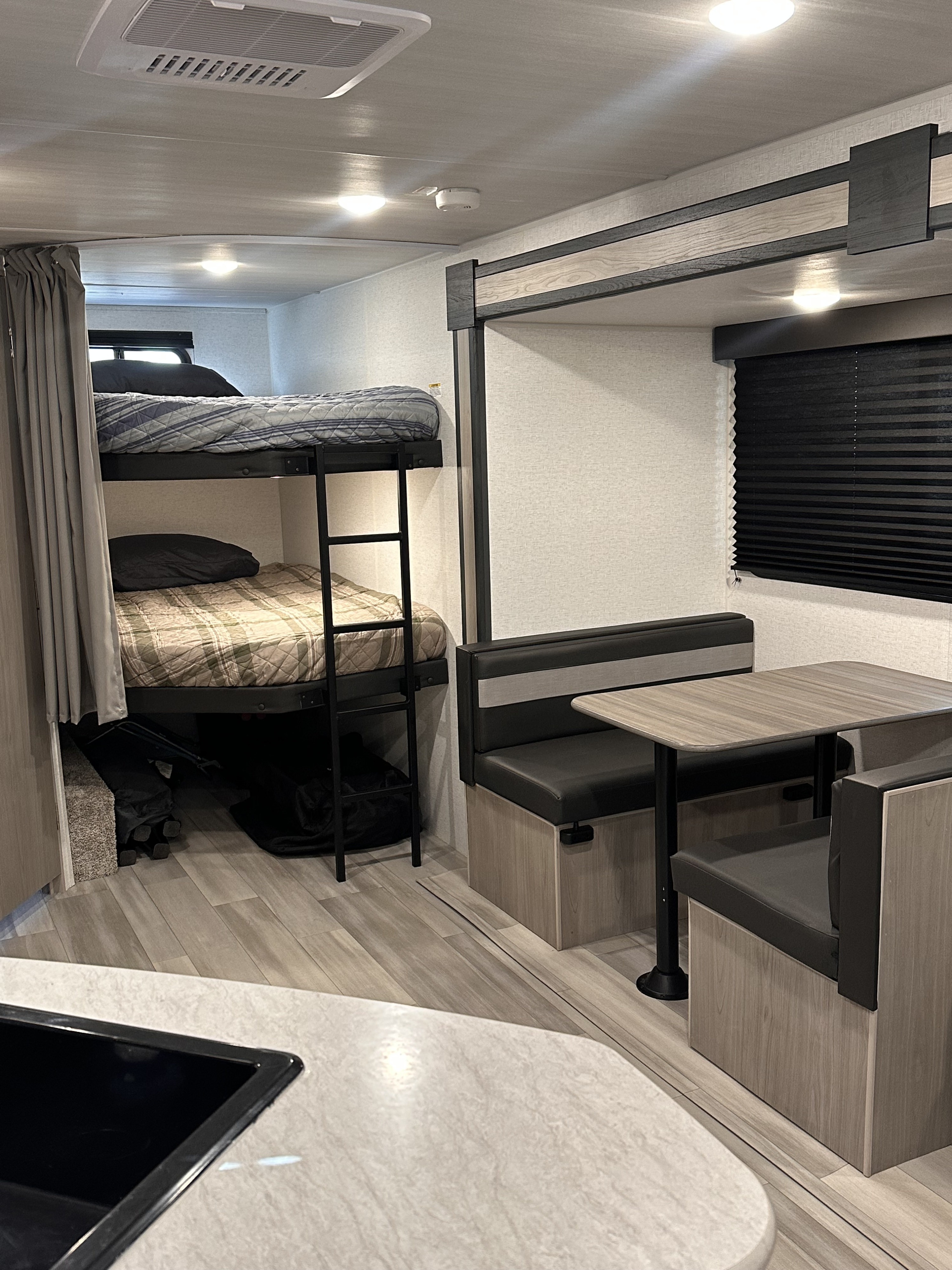 This RV rental offers bunk beds, a dinette, and a cozy interior for a comfortable journey.. Keystone RV Springdale 2024