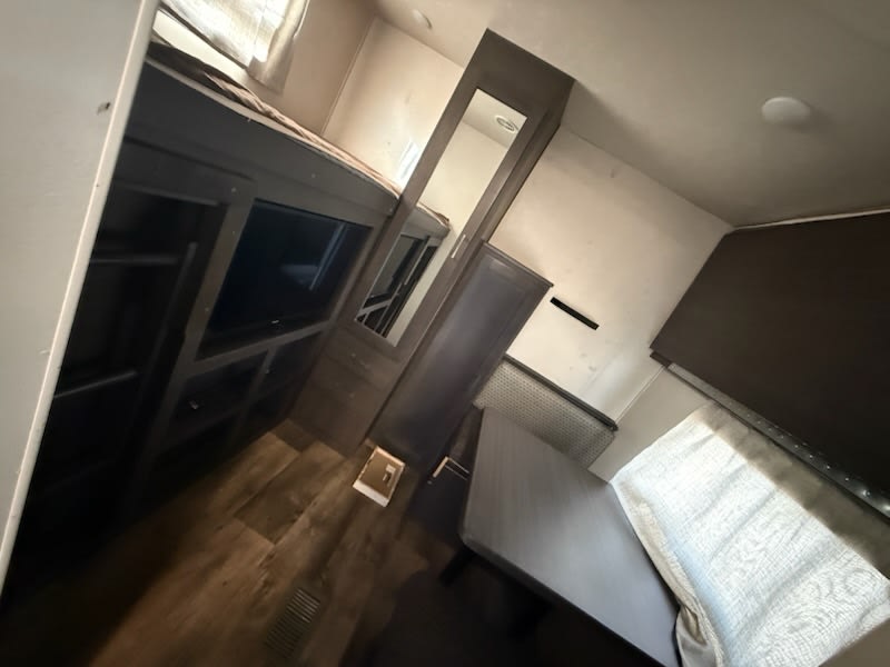 RV rental interior: functional living area with bunk beds, an entertainment center, and a dinette.. Forest River Salem 2019