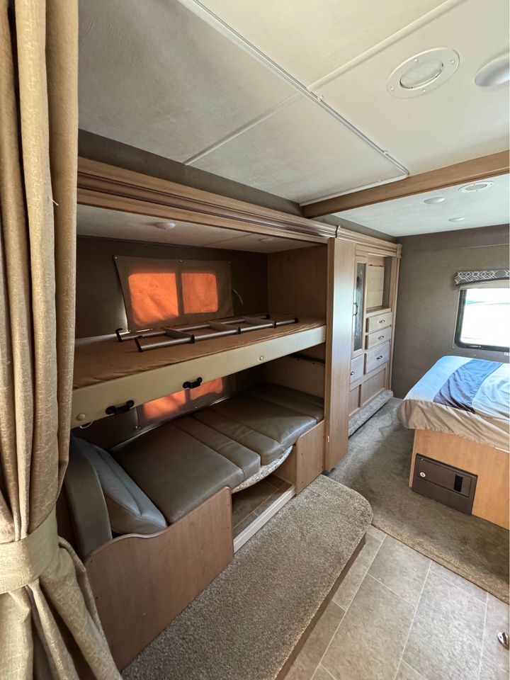 RV rental interior: cozy bunk beds, convertible sofa, & sleeping area for comfort on the road.. Thor Motor Coach Chateau 2019