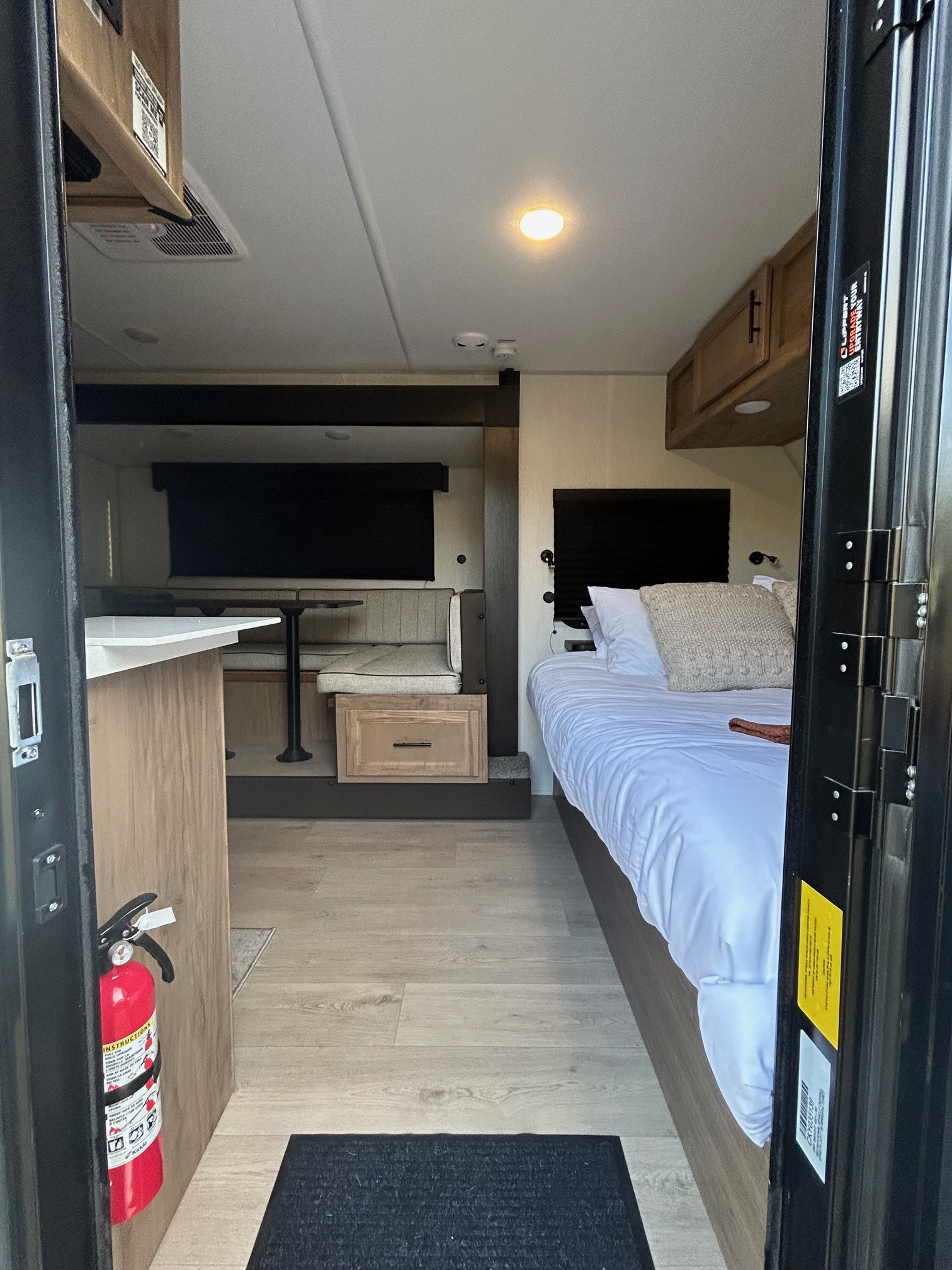 RV rental interior showing a comfortable bed, dinette, and kitchenette.. Forest River RV Cherokee Wolf Pup Black Label 2025