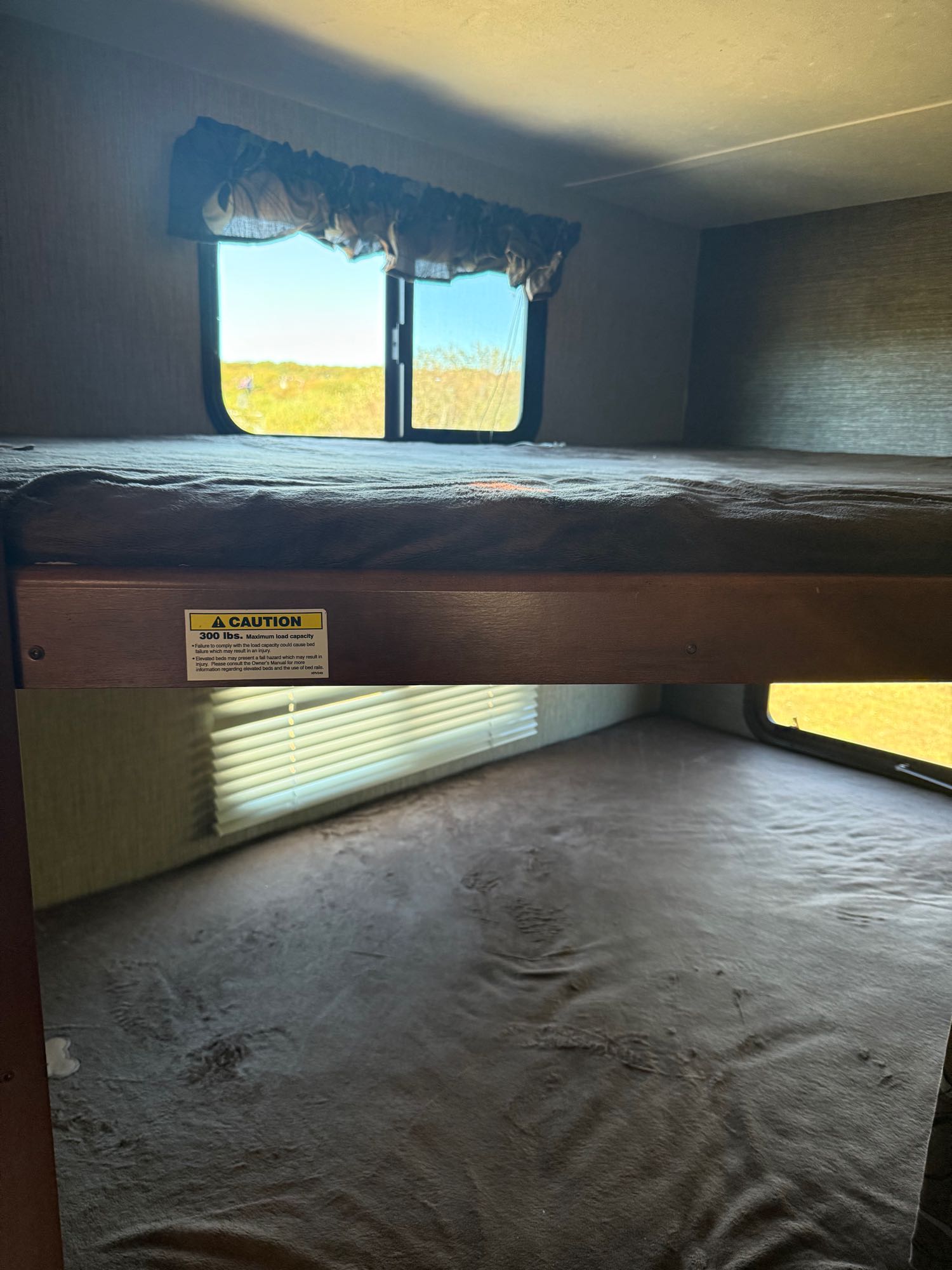 Cozy bunk beds inside an RV rental, offering comfortable sleeping.. Keystone RV Passport Grand Touring 2016