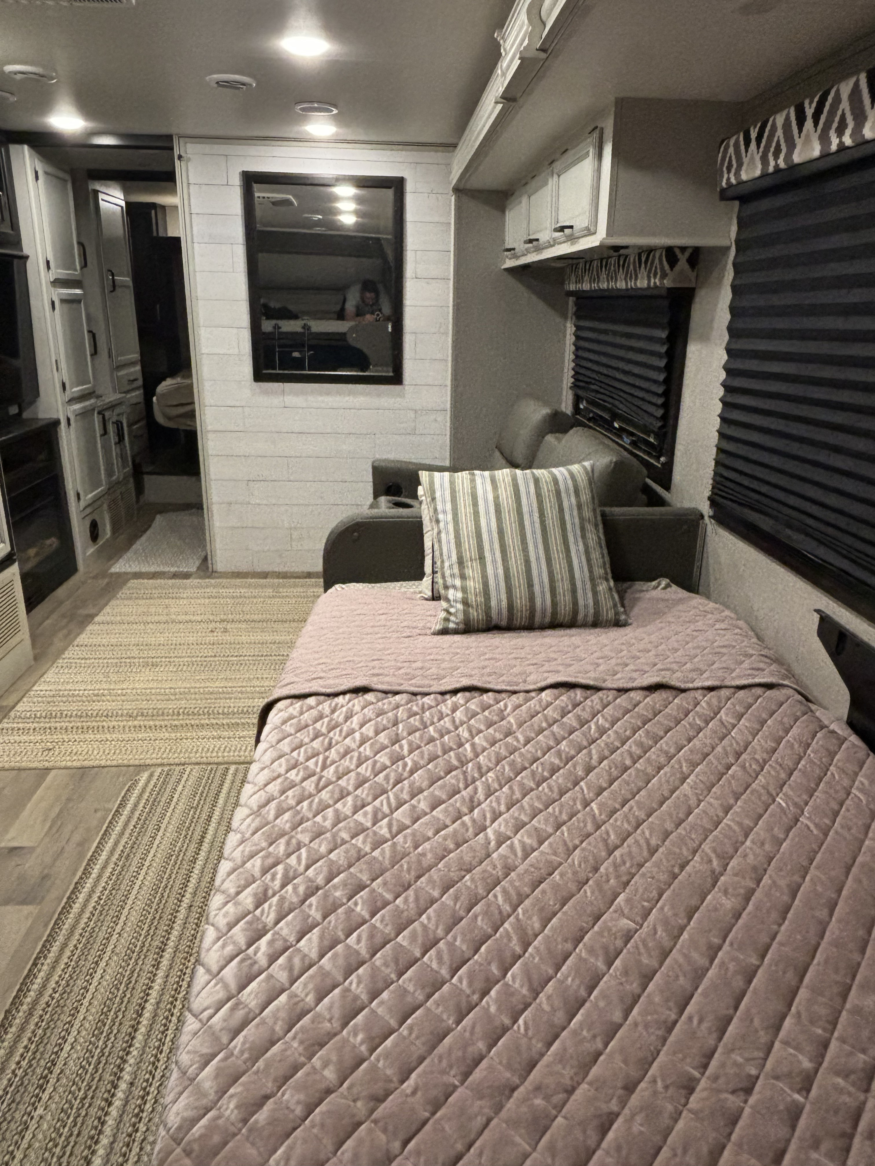 Comfortable RV rental interior features a pull-out bed, sofa, modern decor, and blinds. Perfect for travel.. Entegra Coach Odyssey 2021