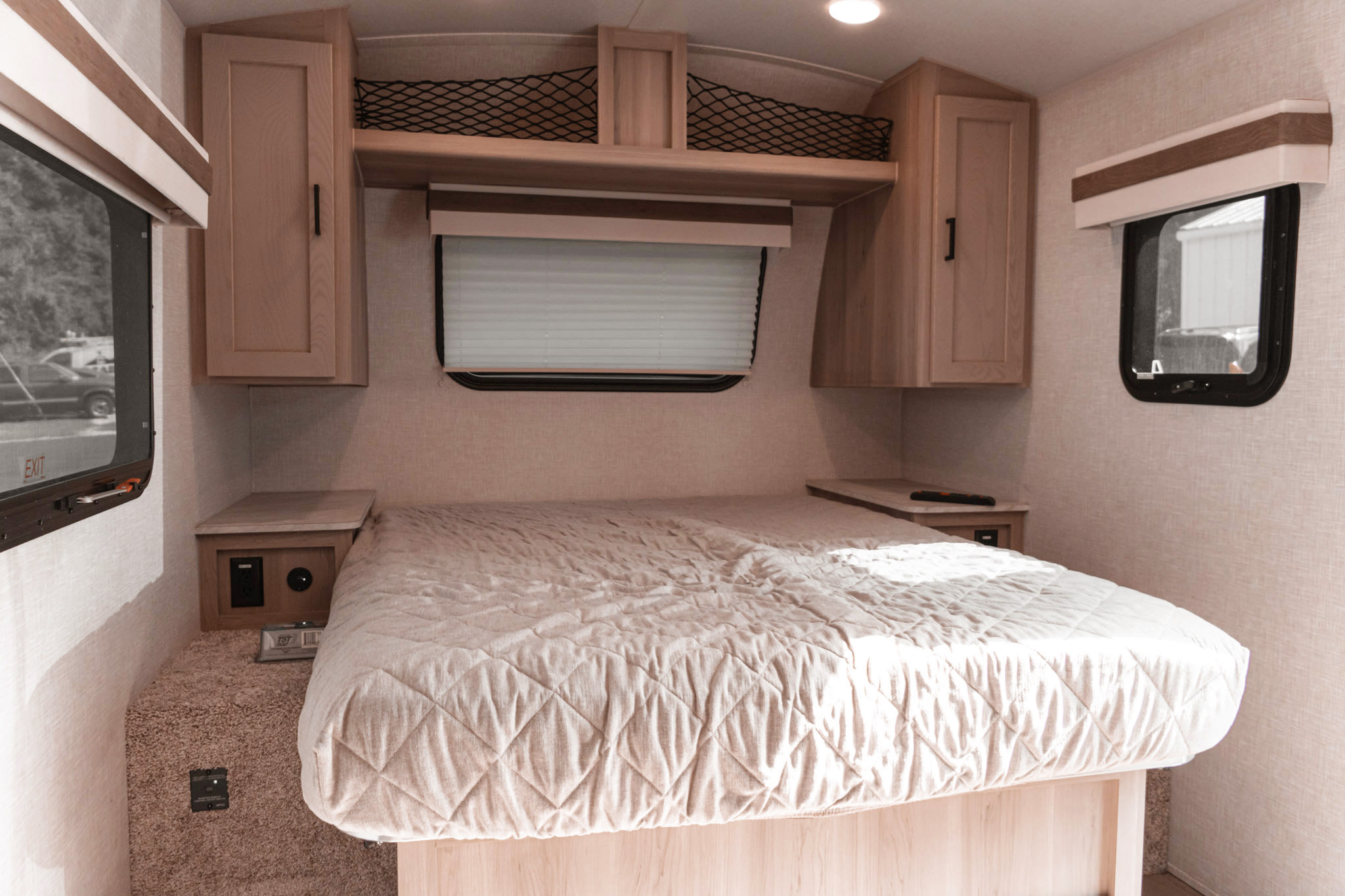 Cozy RV rental bedroom featuring a comfortable bed, overhead storage, and windows. Ideal for road trips and travel comfort.. rockwood Geo Pro G20FBS 2023