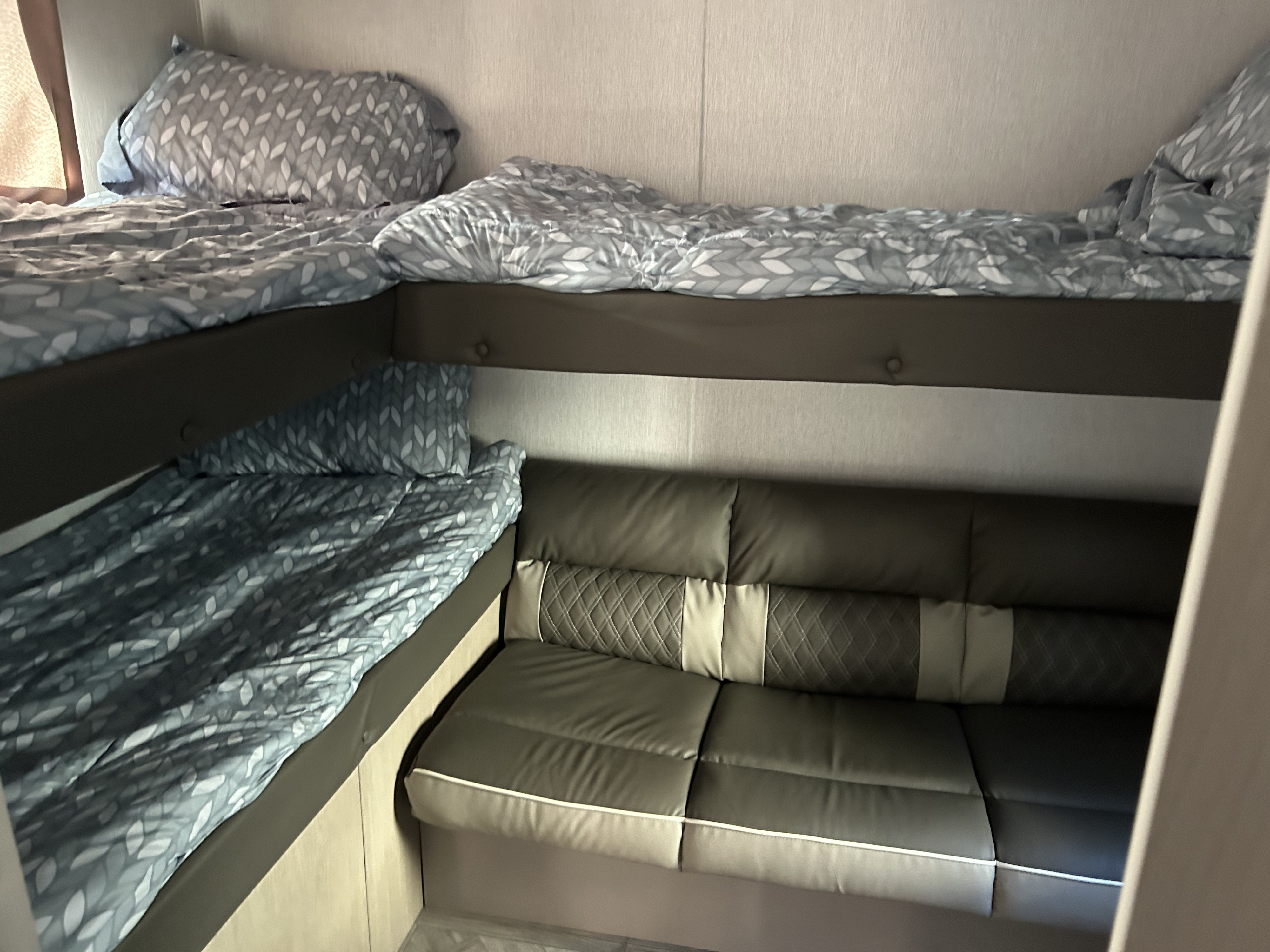 Cozy RV rental interior with bunk beds and versatile seating, perfect for family adventures.. Forest River Salem Cruise Lite Platinum 2024