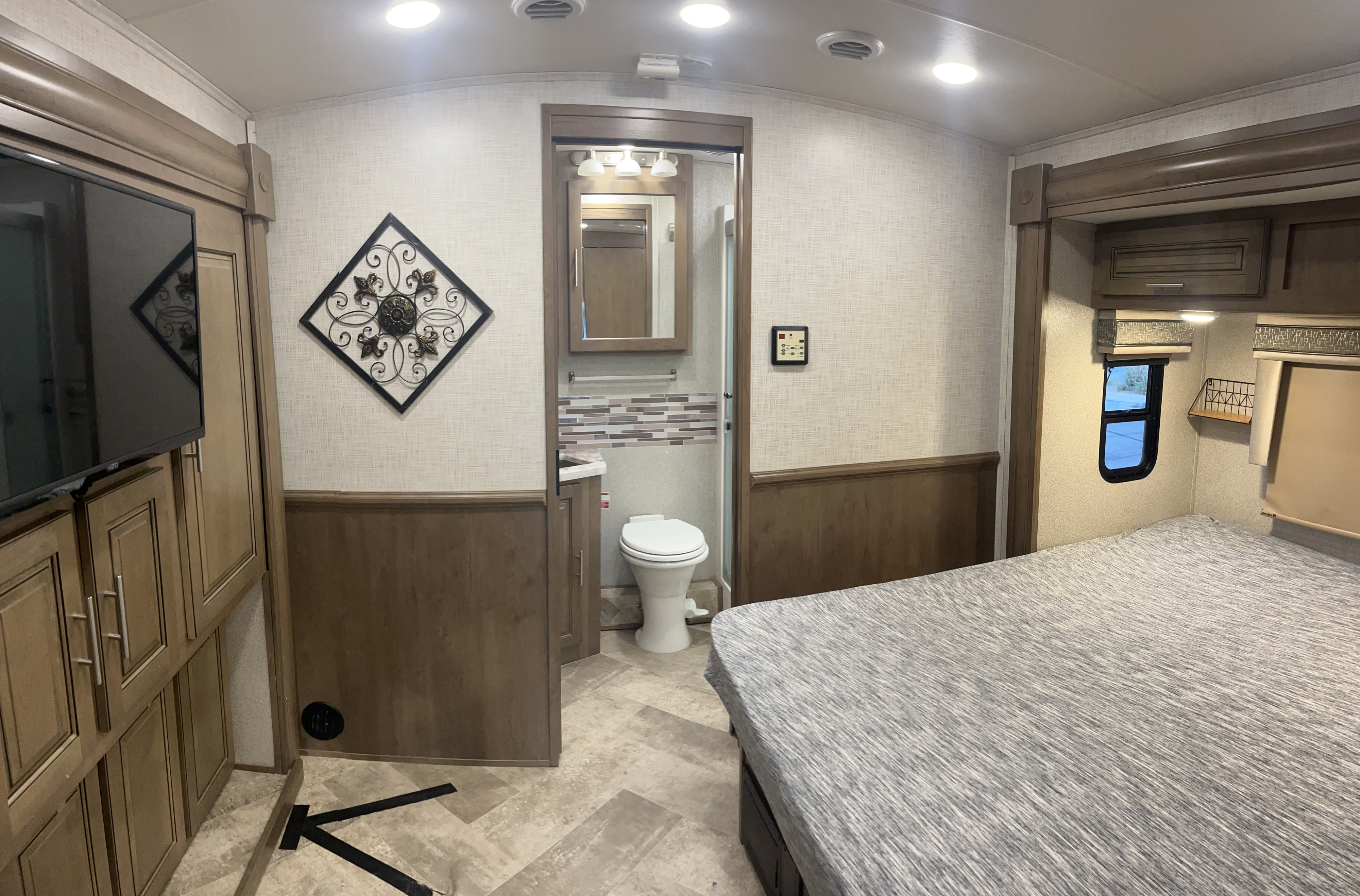 Comfortable RV rental bedroom with TV & storage, plus a compact bathroom. Modern interior for your next adventure.. Forest River Georgetown 2019