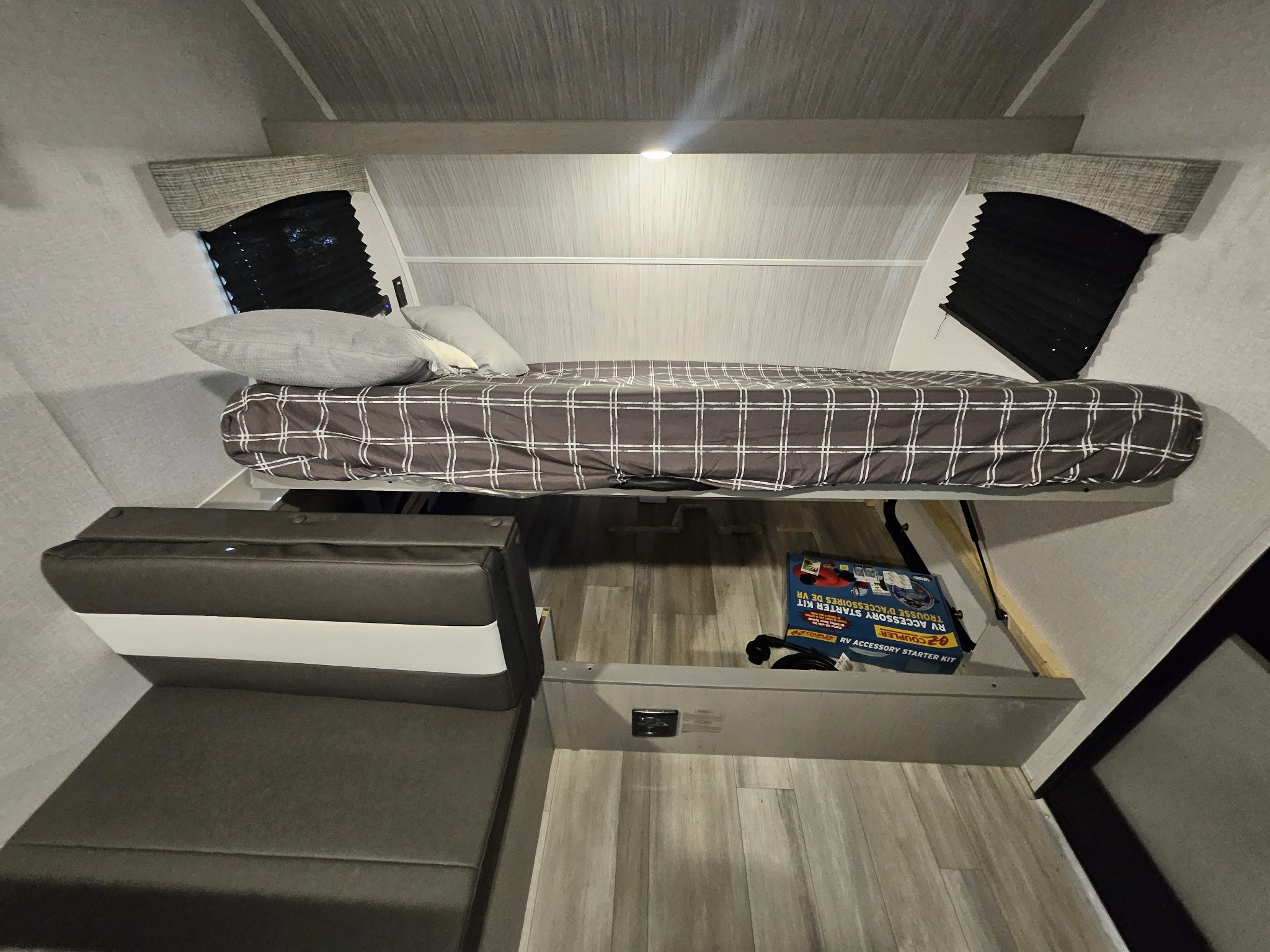 Explore this RV rental's interior: a raised bed, adaptable seating, and useful under-bed storage with an accessory kit.. Forest River Clipper Towable 2023