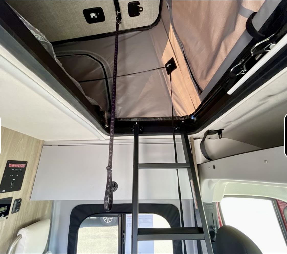 RV rental interior: Access the comfy pop-top bed via the ladder, a unique elevated sleeping space.. solis 59px 2025
