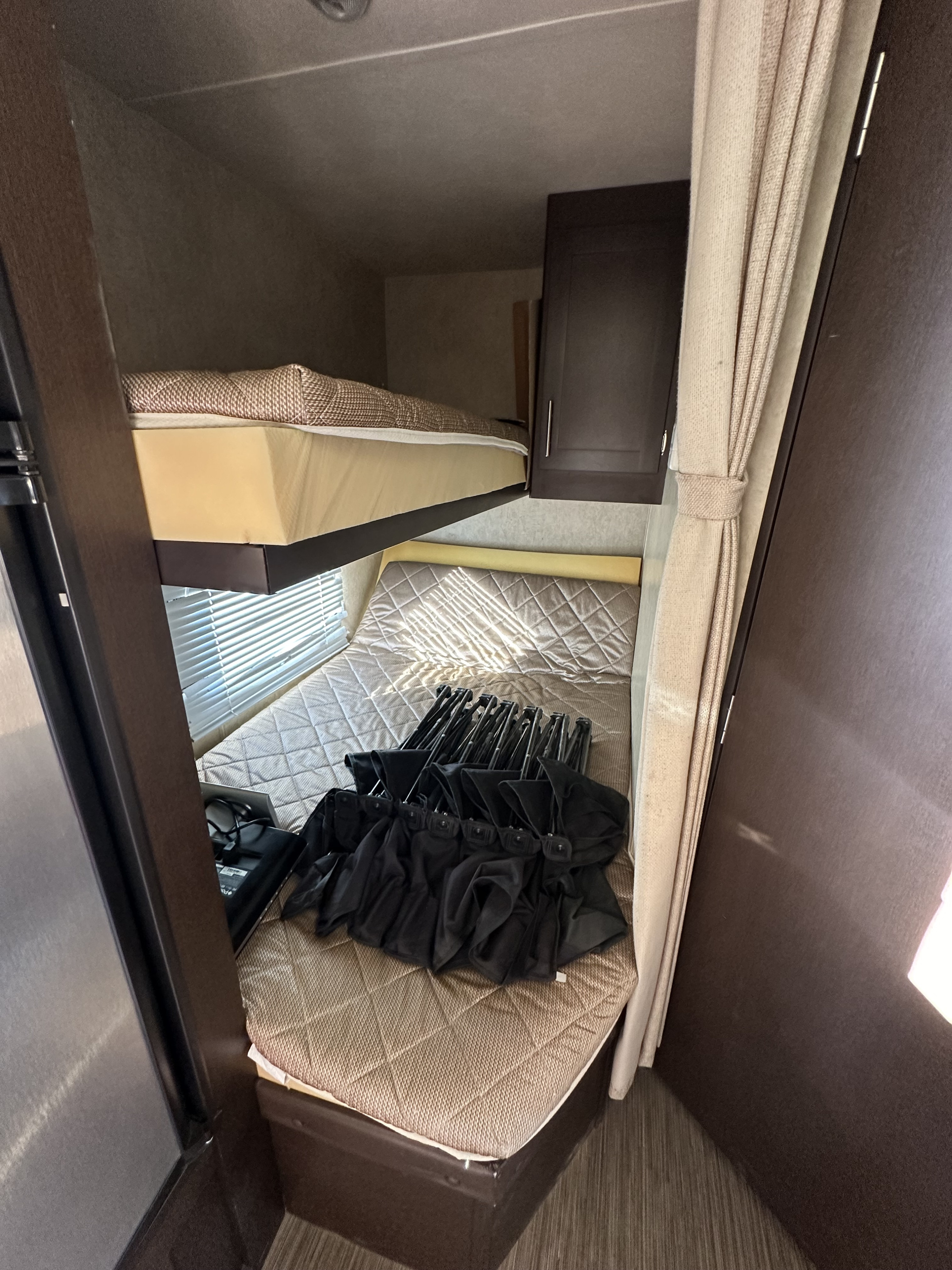RV rental: bunk bed area featuring upper and lower bunks. The lower bunk holds black foldable chairs near a window.. Forest River Forest River Evo 2014