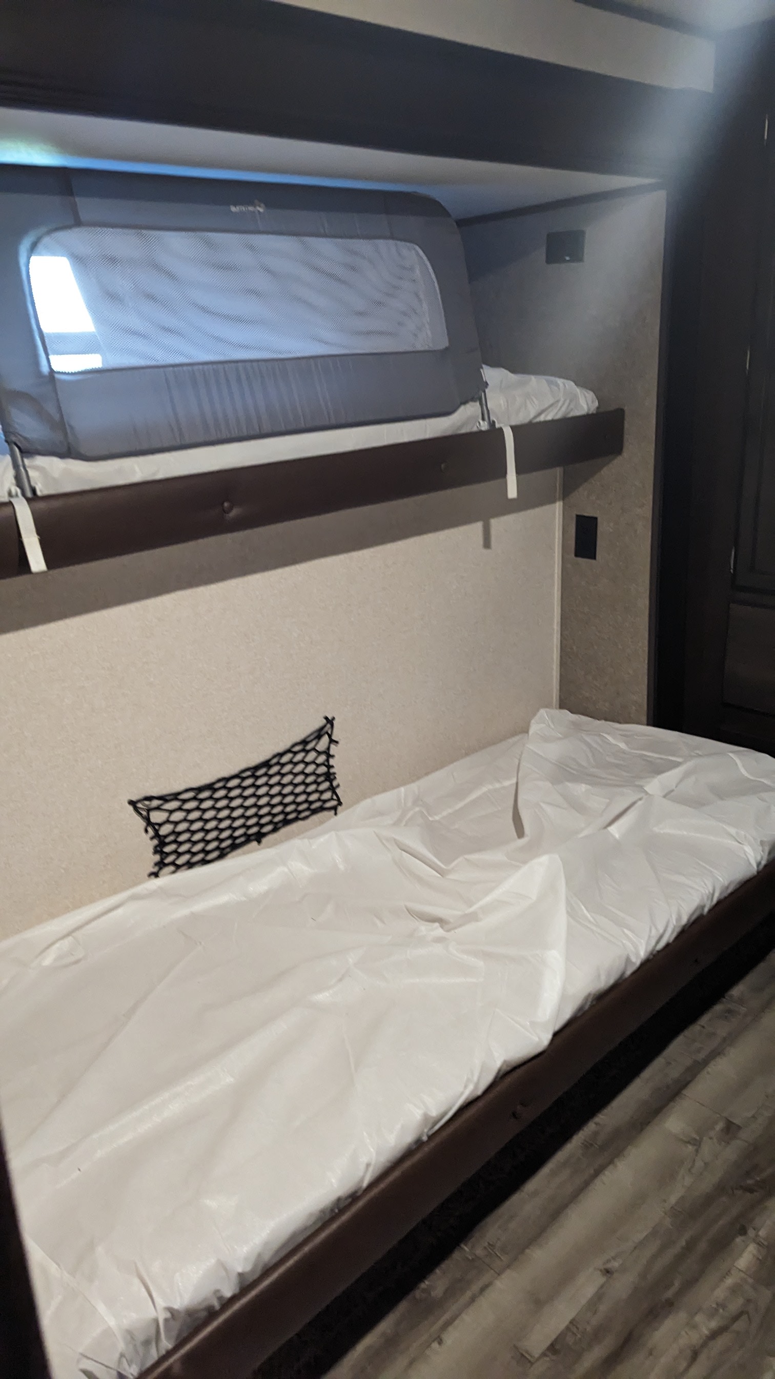 This **RV rental** interior features bunk beds with protective covers. Top bunk has a child safety rail. Perfect for families.. Jayco Jay Flight 2018
