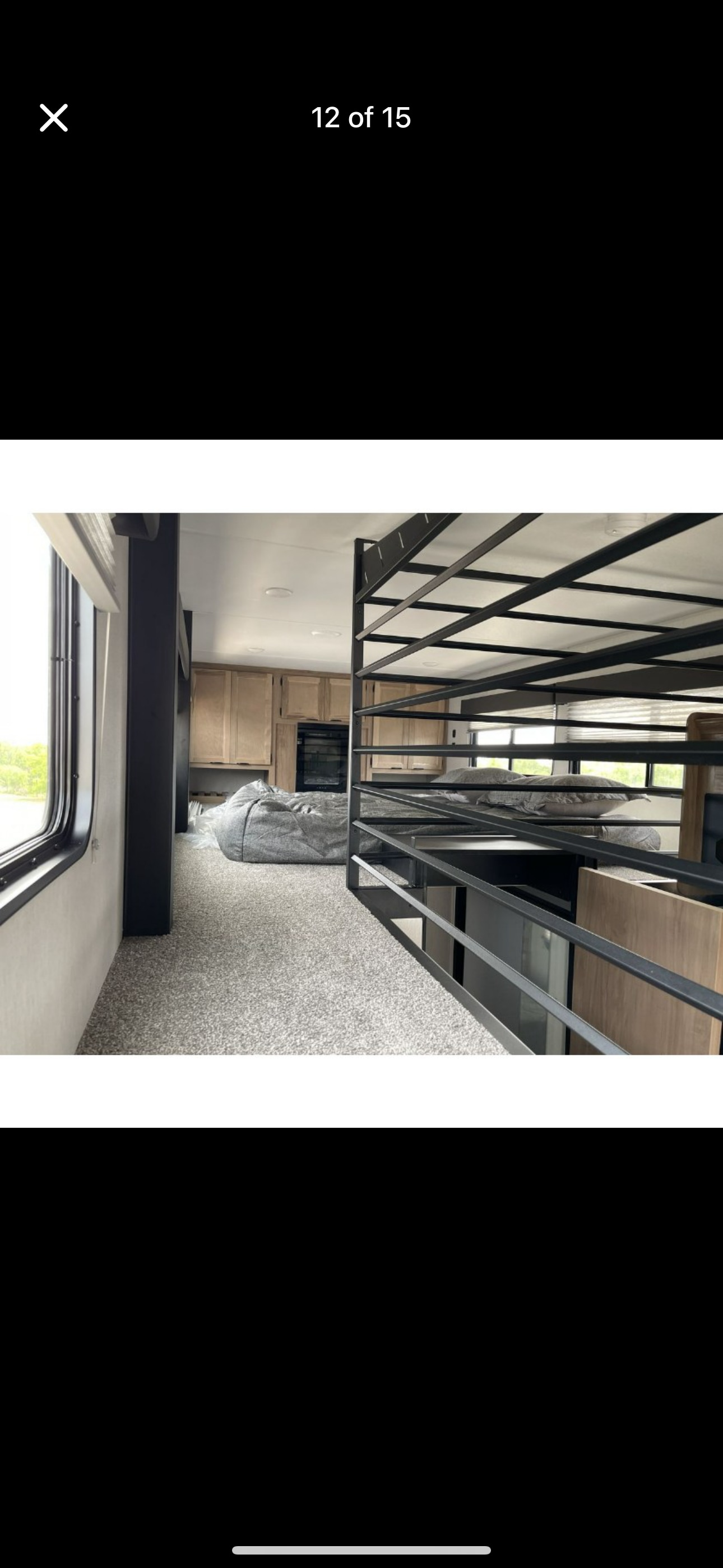 RV rental: Interior of an RV showing kitchen, carpeted living space with a beanbag, and a bunk bed loft.. Forest River Timberwolf 20OG 2024
