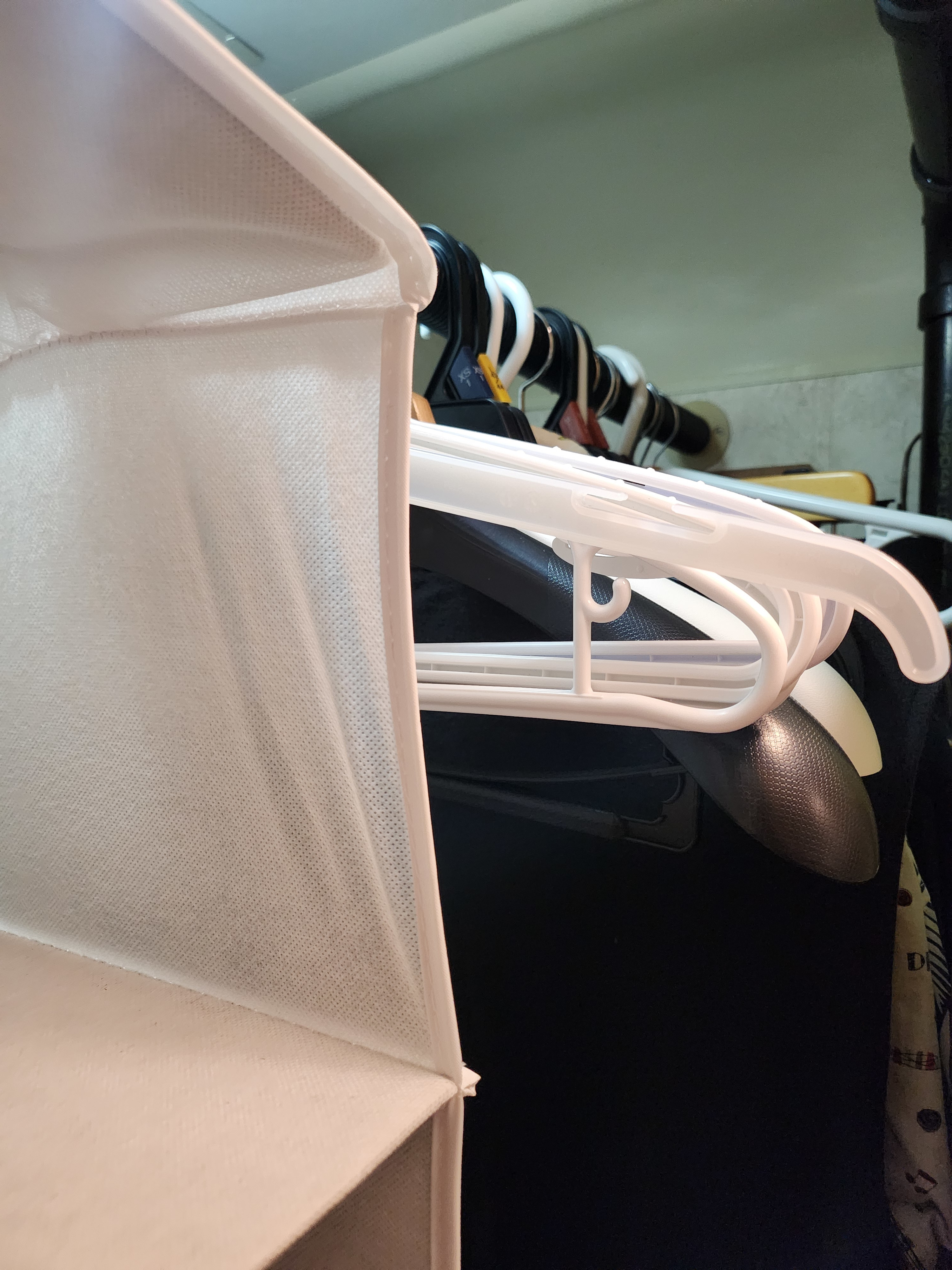 Inside a compact rv rental closet: white hanging organizer and hangers offer smart storage solutions for clothes.. Winnebago Vista 2003