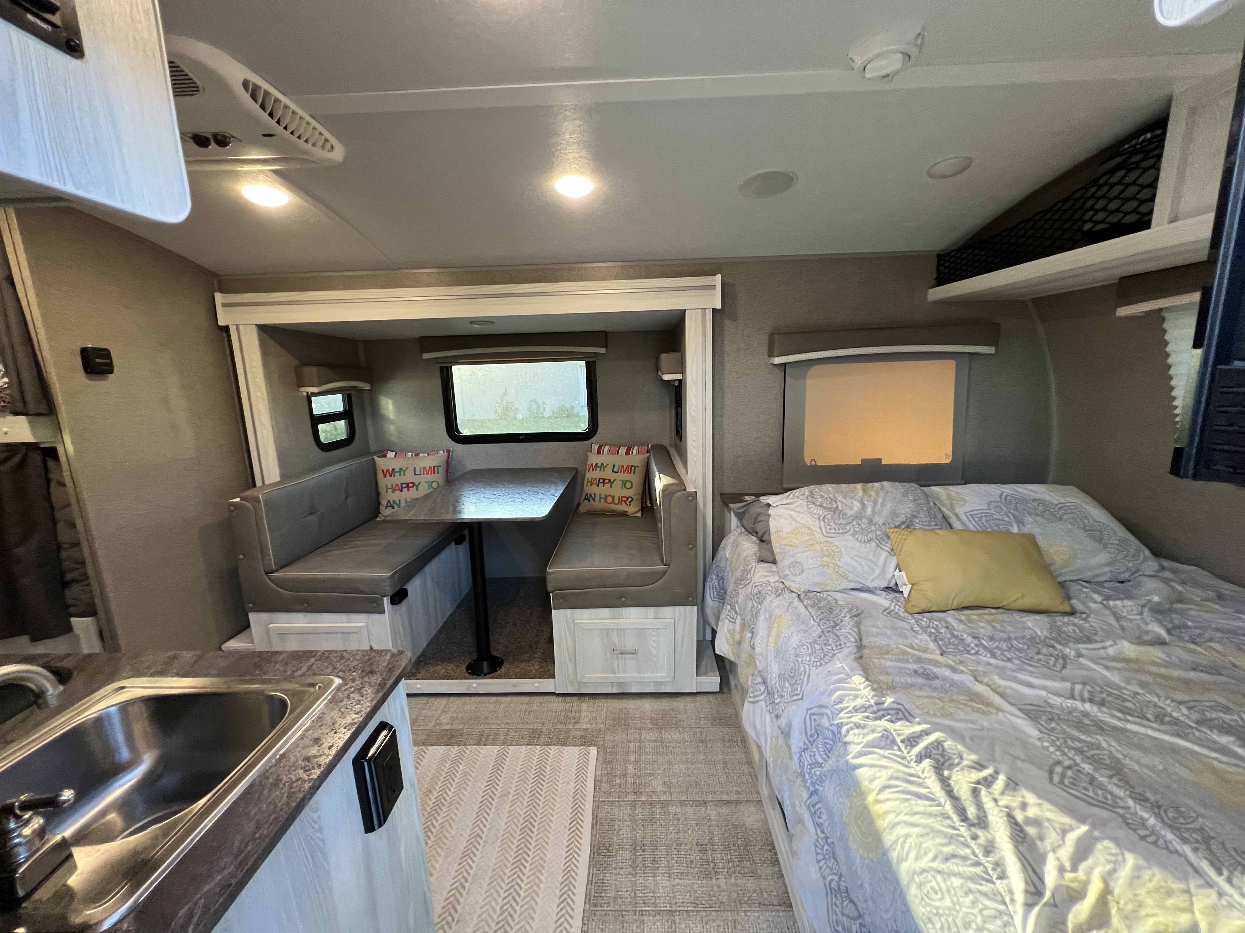 Spacious RV rental interior featuring a dinette, comfy bed, and kitchen sink. Perfect for your next adventure.. Forest River Rockwood Geo Pro 2020