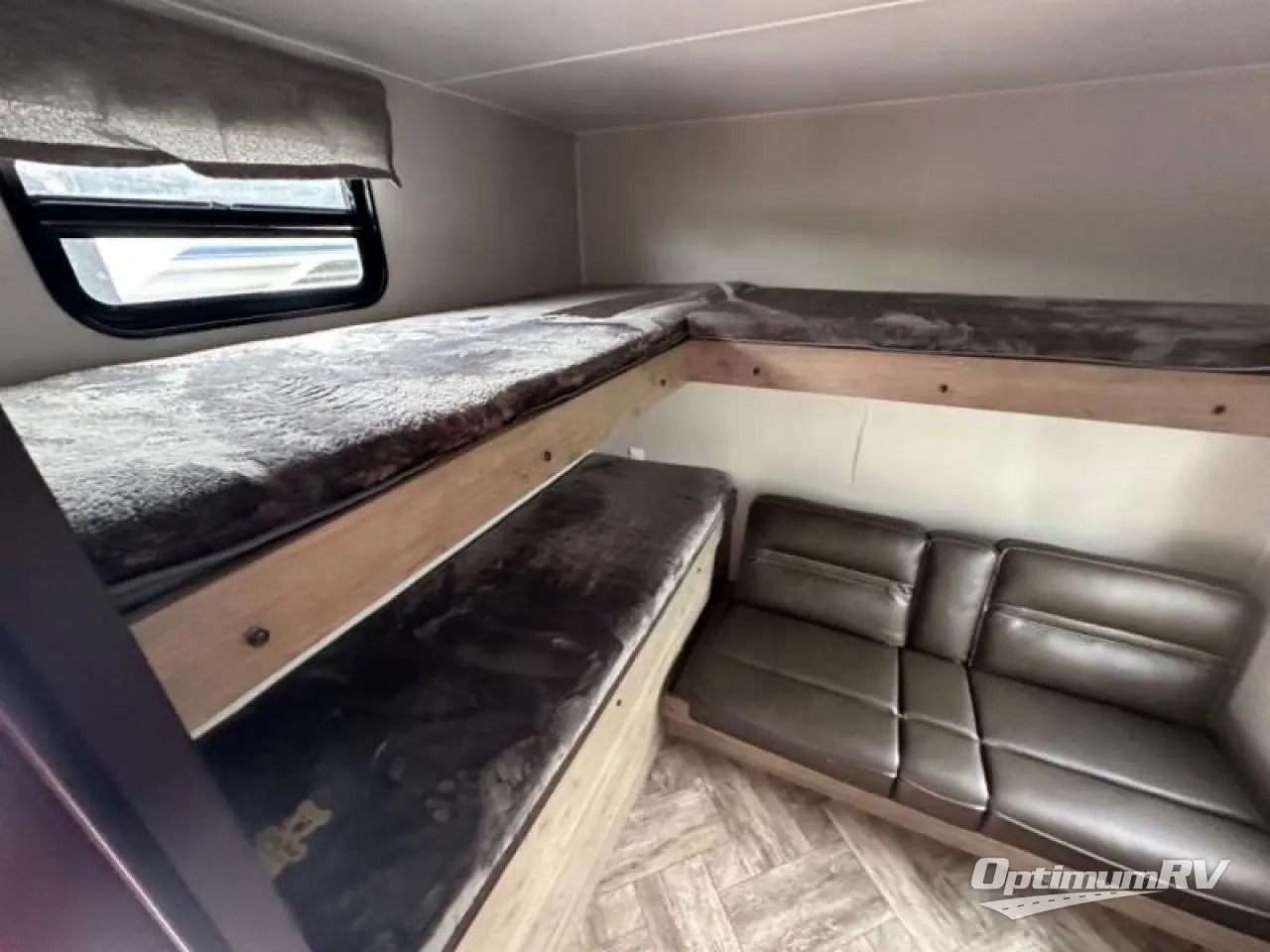 Spacious RV rental interior featuring L-shaped bunk beds with soft cushions and a comfortable sofa below.. Palomino Puma 2022
