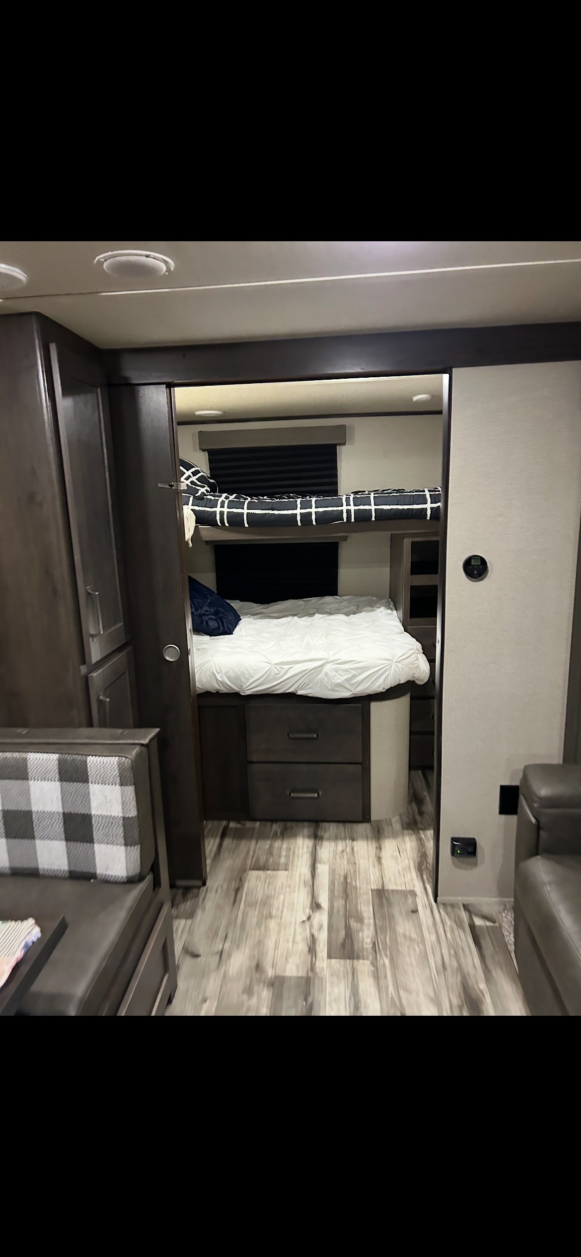 Modern RV rental interior showcasing cozy bunk beds, a versatile dinette, and comfortable seating for family adventures.. Grand Design Transcend Xplor 2024